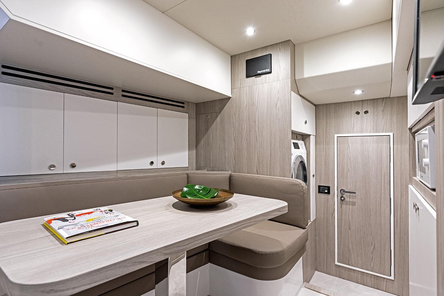 Luxurious interior of 2025 Azimut Grande 26M yacht with modern seating and cabinetry.