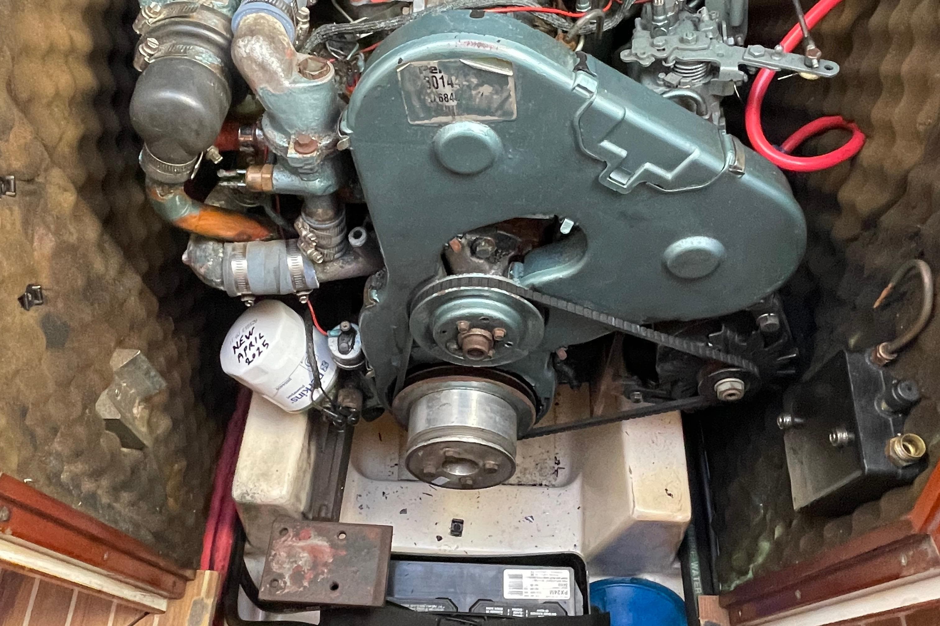 Engine compartment of a 1995 Beneteau Oceanis 400 sailboat, showcasing mechanical components.