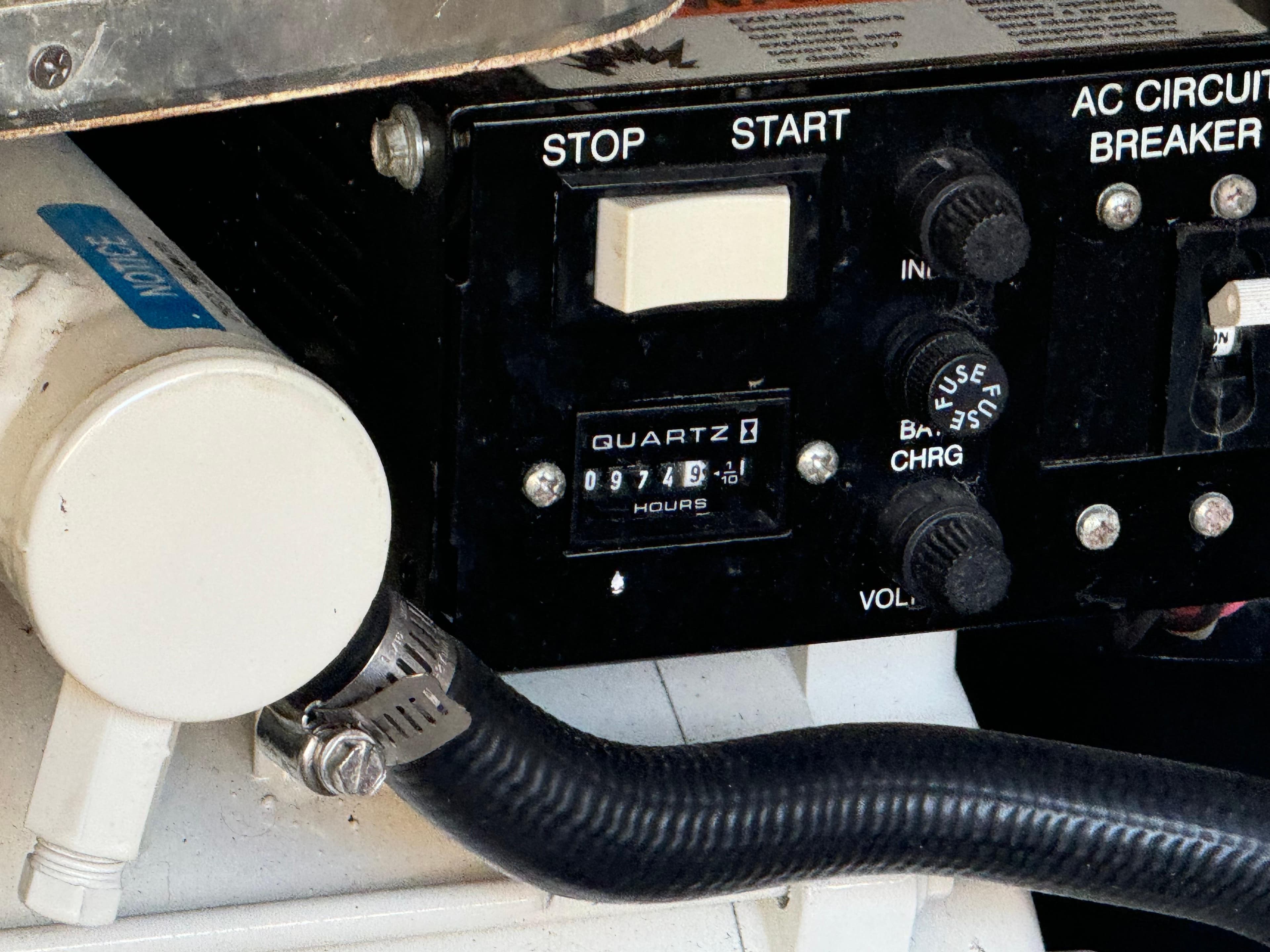 Control panel of a 2004 Formula 37 Performance Cruiser with hour meter and circuit breaker.