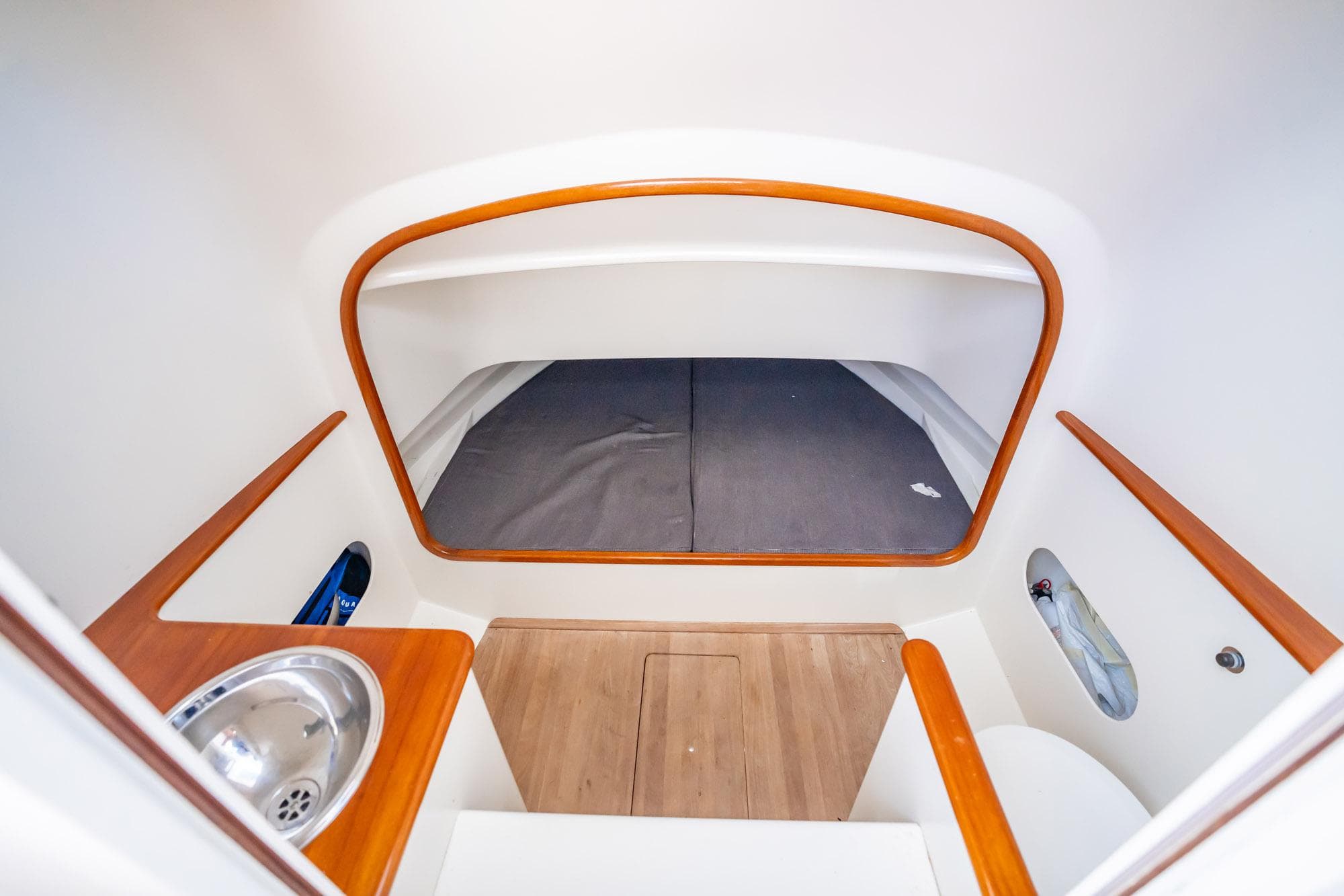 Interior cabin of 2003 Gamefisherman 34 Express boat with wood accents and compact design.