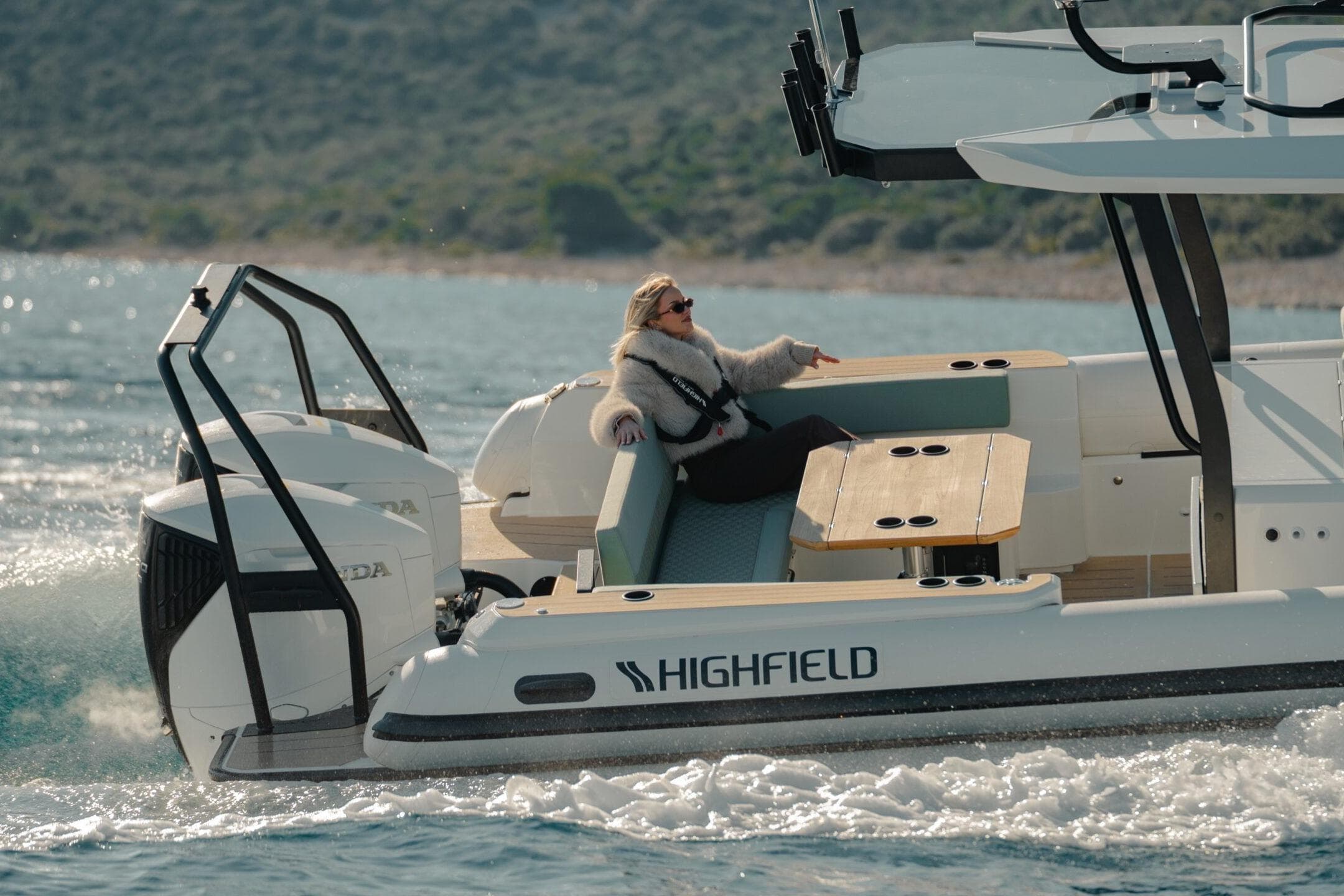 2026 Highfield ADV7 boat cruising with a relaxed passenger on deck.