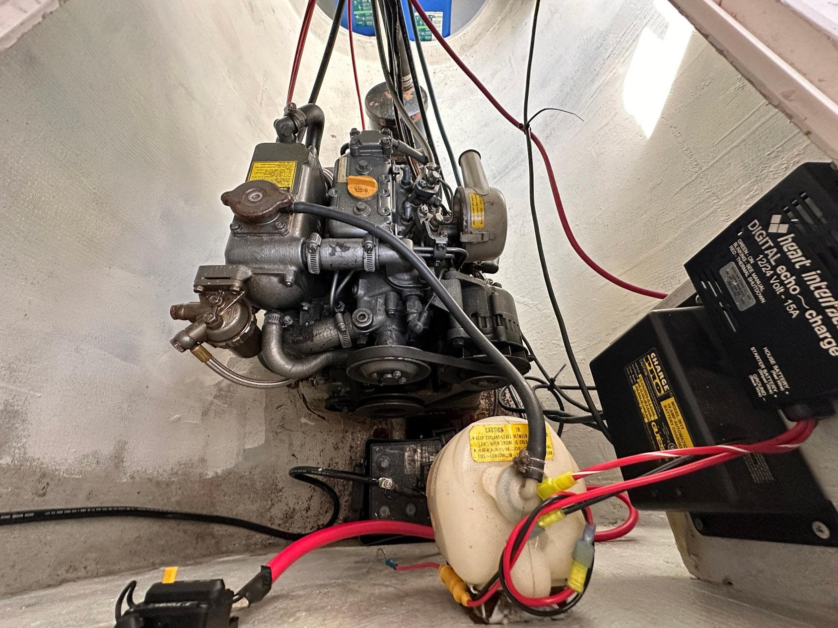 Engine compartment of a 1993 Russell Yachts Crowther, showcasing mechanical components and wiring.