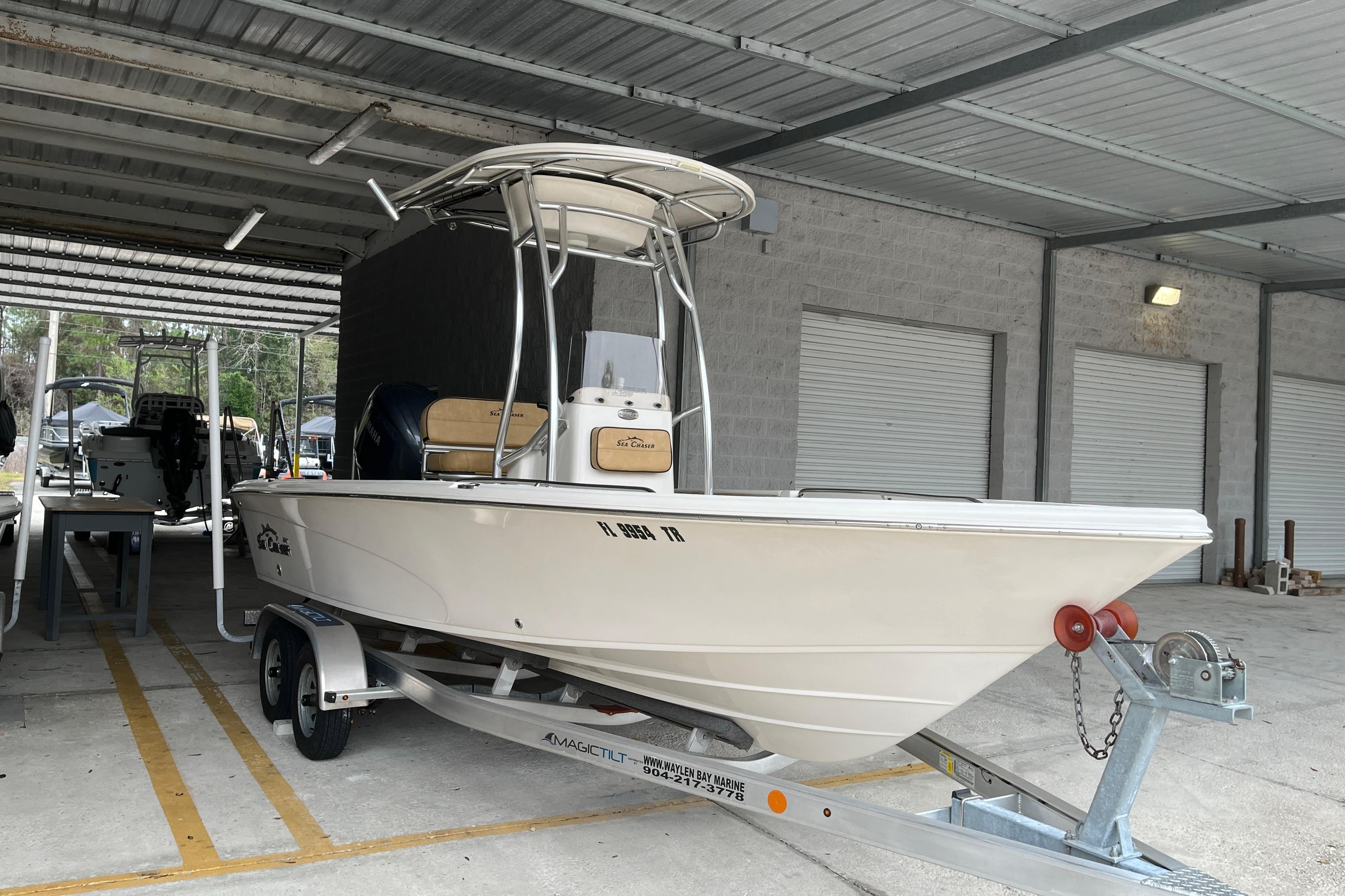 2024 Sea Chaser 21 LX boat on trailer in covered storage area.