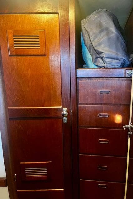 Wooden interior of 1974 Spencer Yachts 1330, featuring cabinets and storage space.