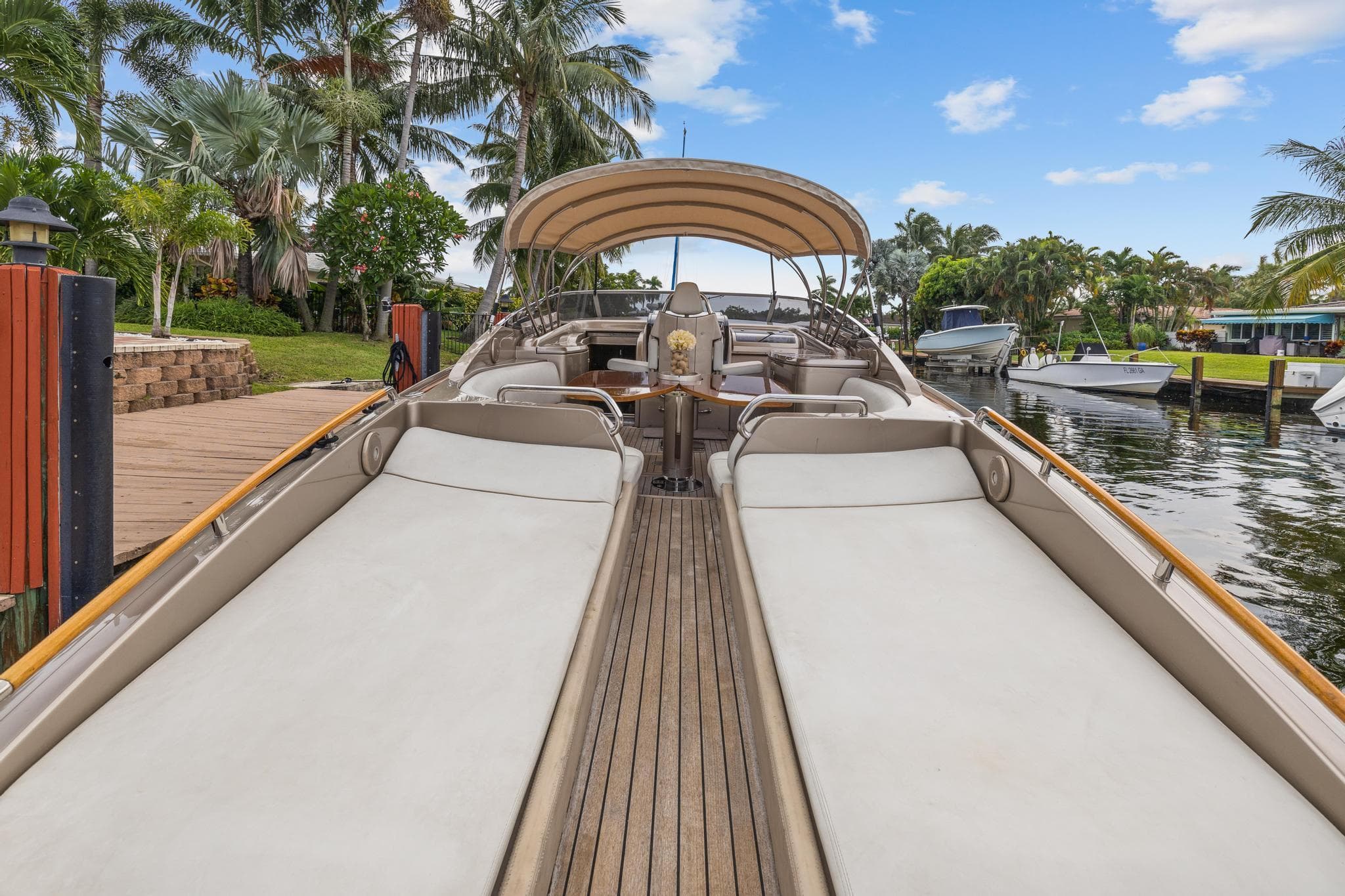 Luxury 2010 Riva Rama yacht docked, featuring spacious sunbeds and elegant design.