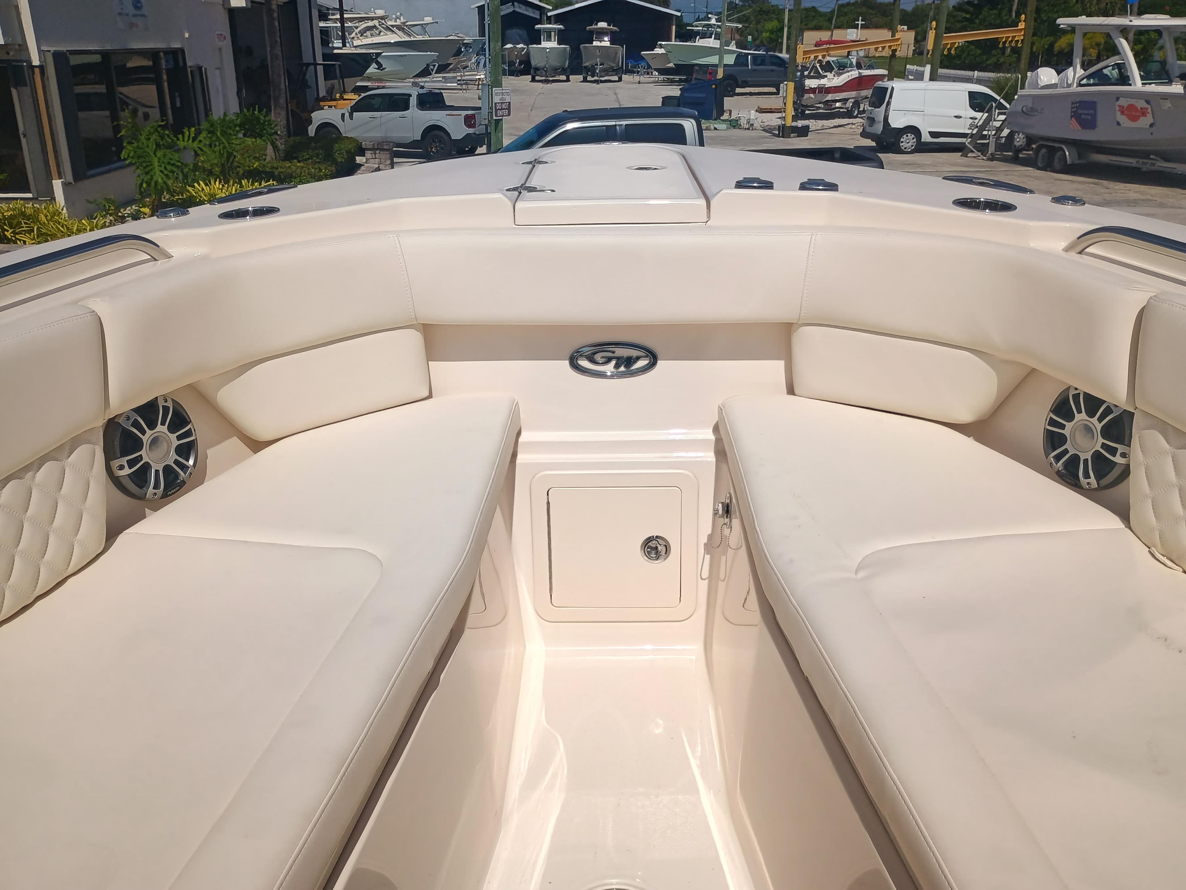 2025 Grady-White Canyon 456 boat interior with cushioned seating and storage compartment.