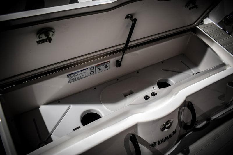 2023 Yamaha Boats AR220 storage compartment with open lid.
