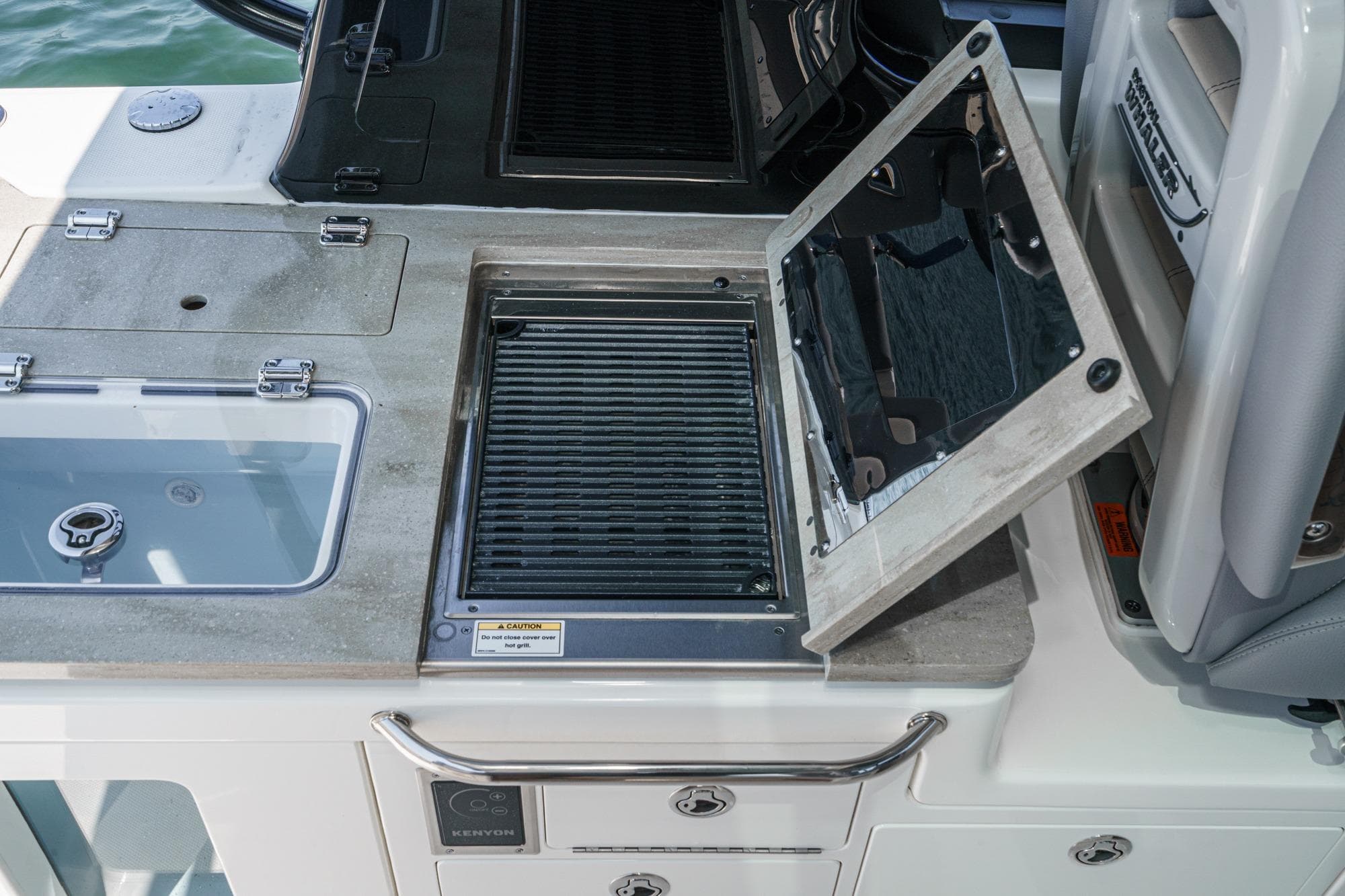 2024 Boston Whaler 380 Realm boat grill and sink setup on deck.