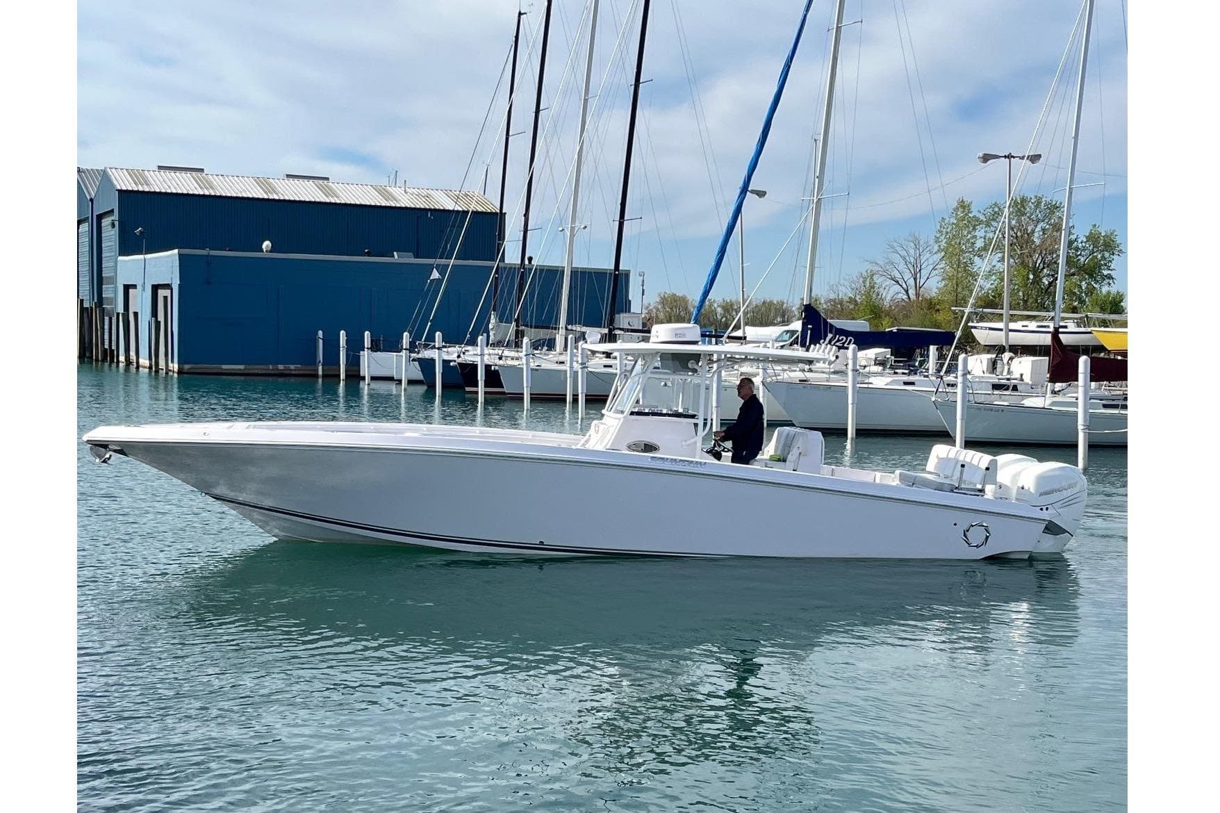 2018 Fountain 38 Center Console boat docked in marina, clear sky background.