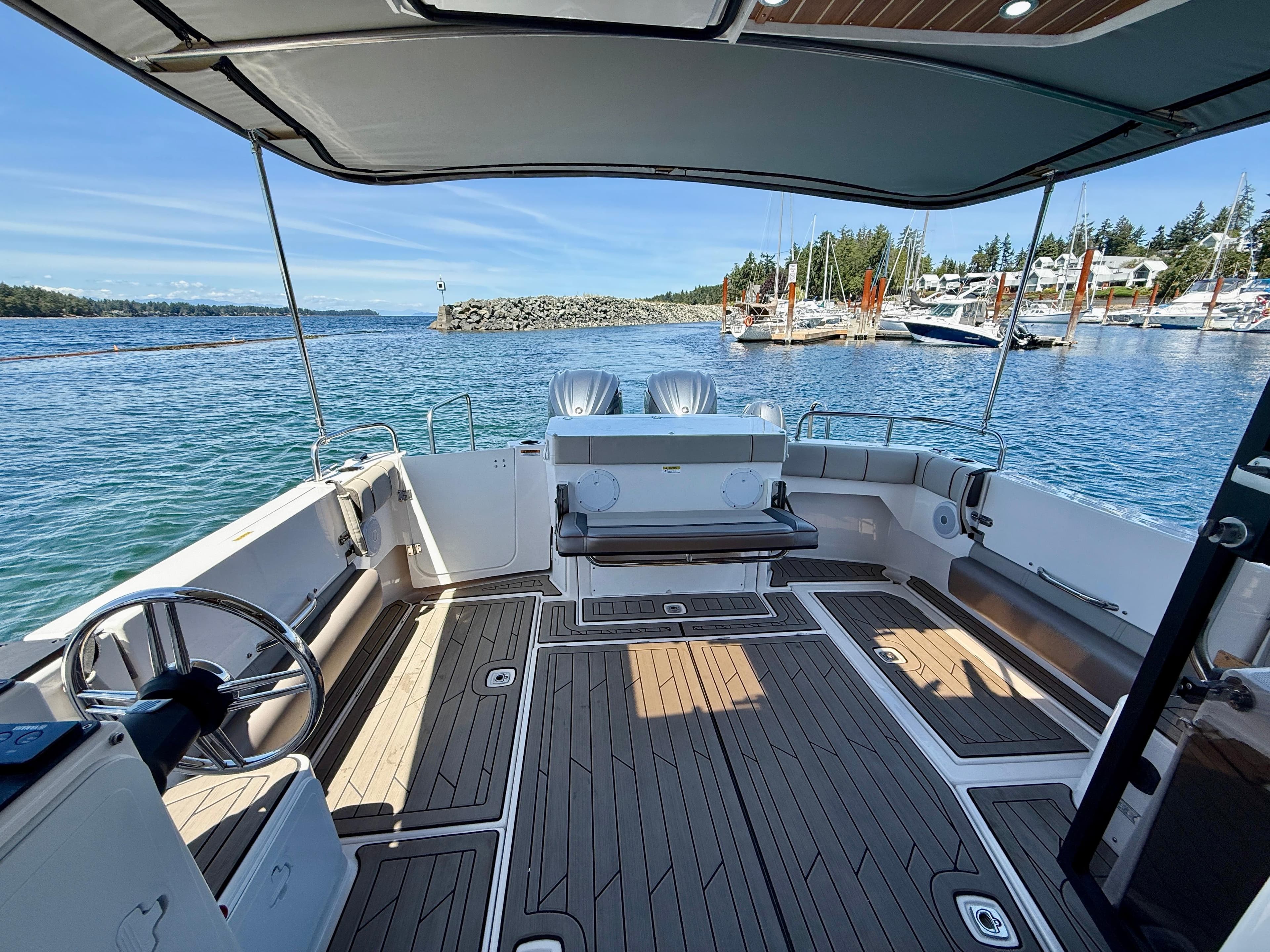 2022 Cutwater C-32 C boat interior with spacious deck and scenic marina view.