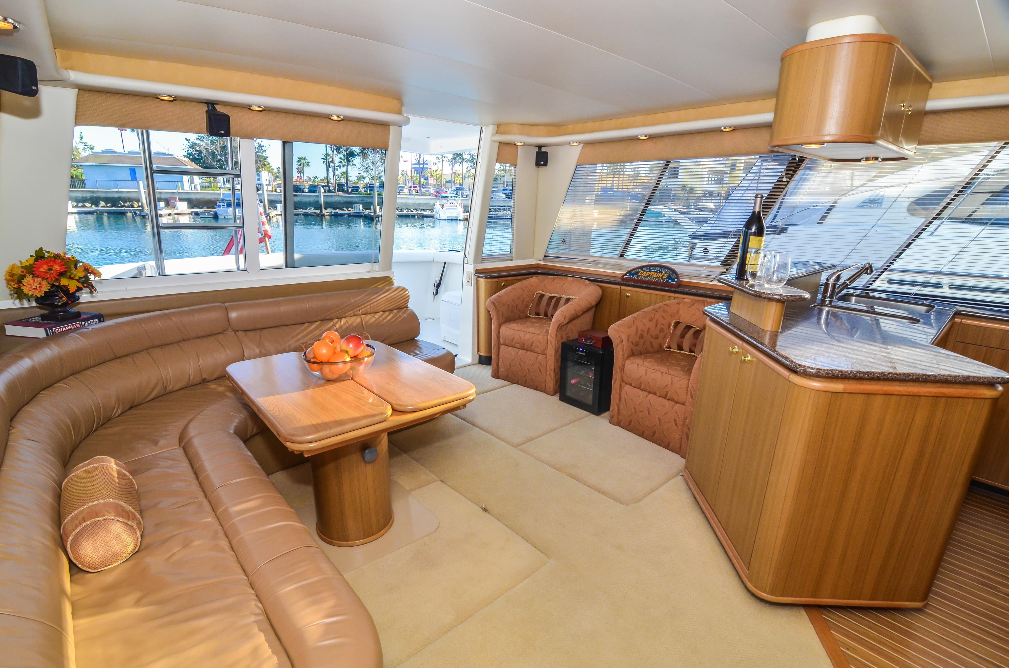 Luxurious interior of 2002 Bayliner 4788 Pilot House Motoryacht with leather seating and kitchenette.