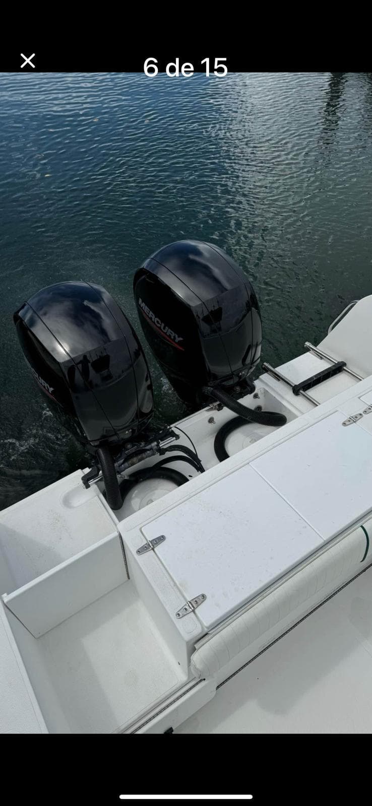2000 Stamas 250 Tarpon boat with dual outboard engines on calm water.