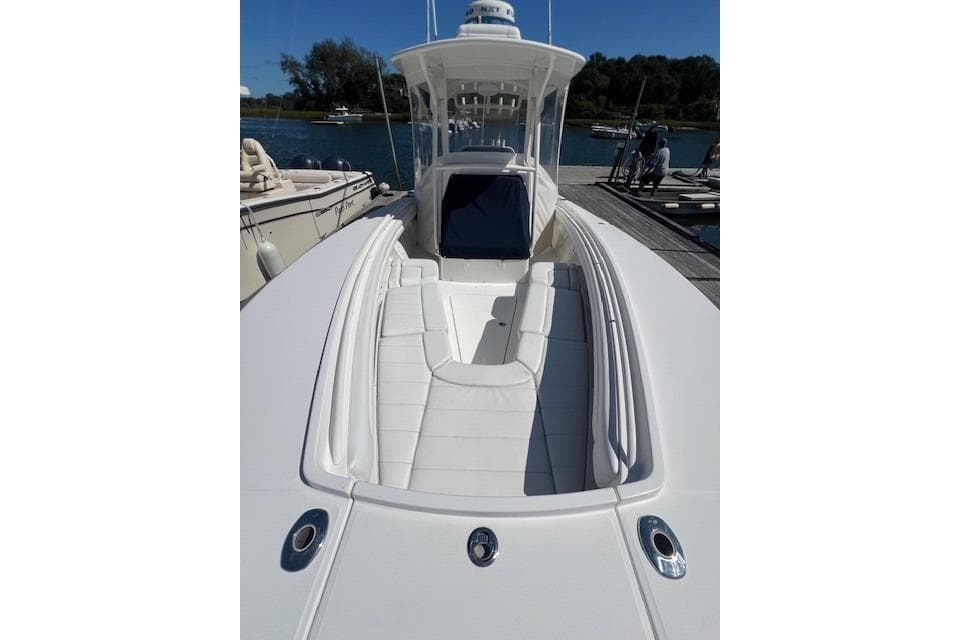2017 Regulator 31 boat with sleek white deck and seating, docked by the water.