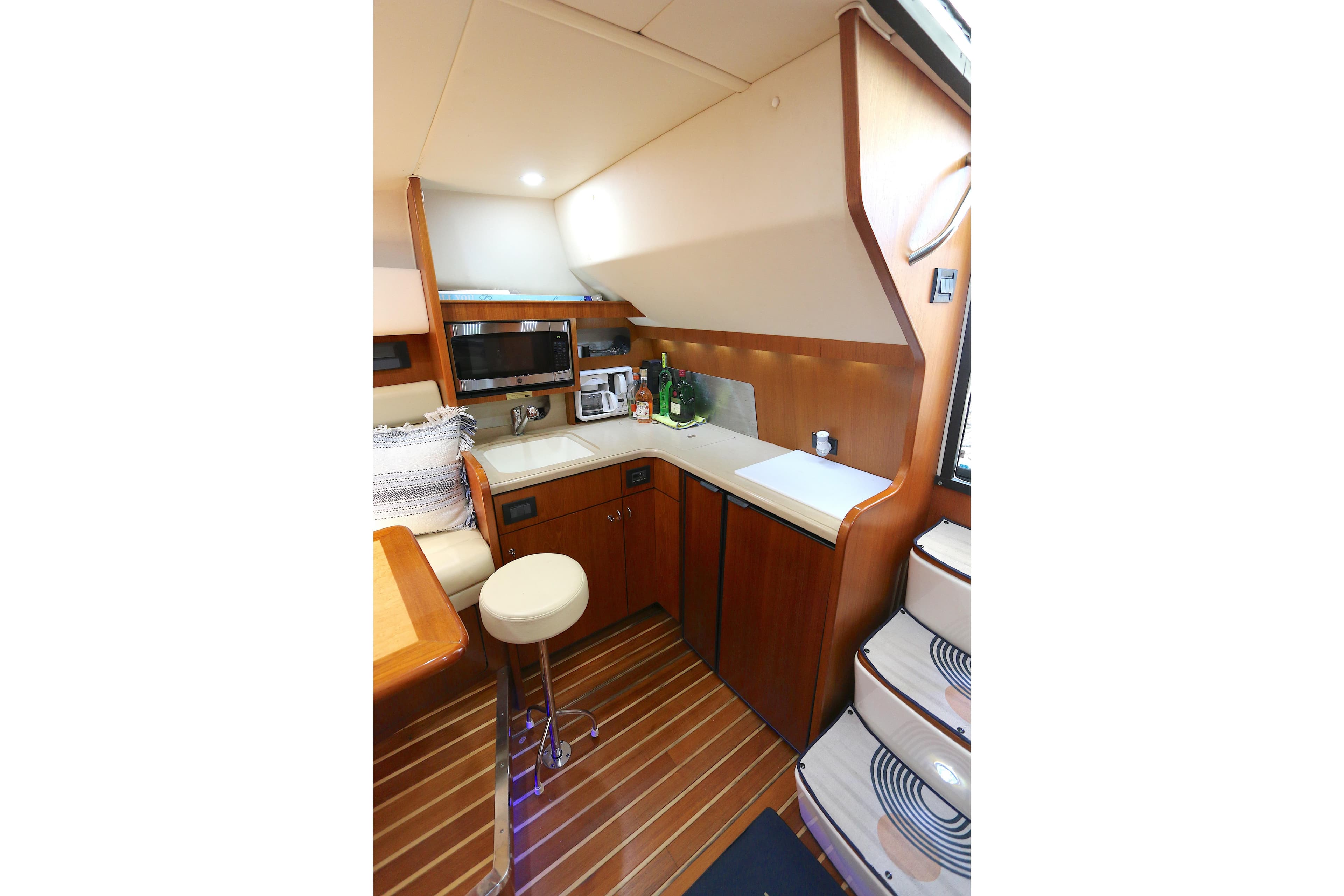 2005 Tiara Yachts 3800 Open interior kitchen with wood cabinetry and modern appliances.
