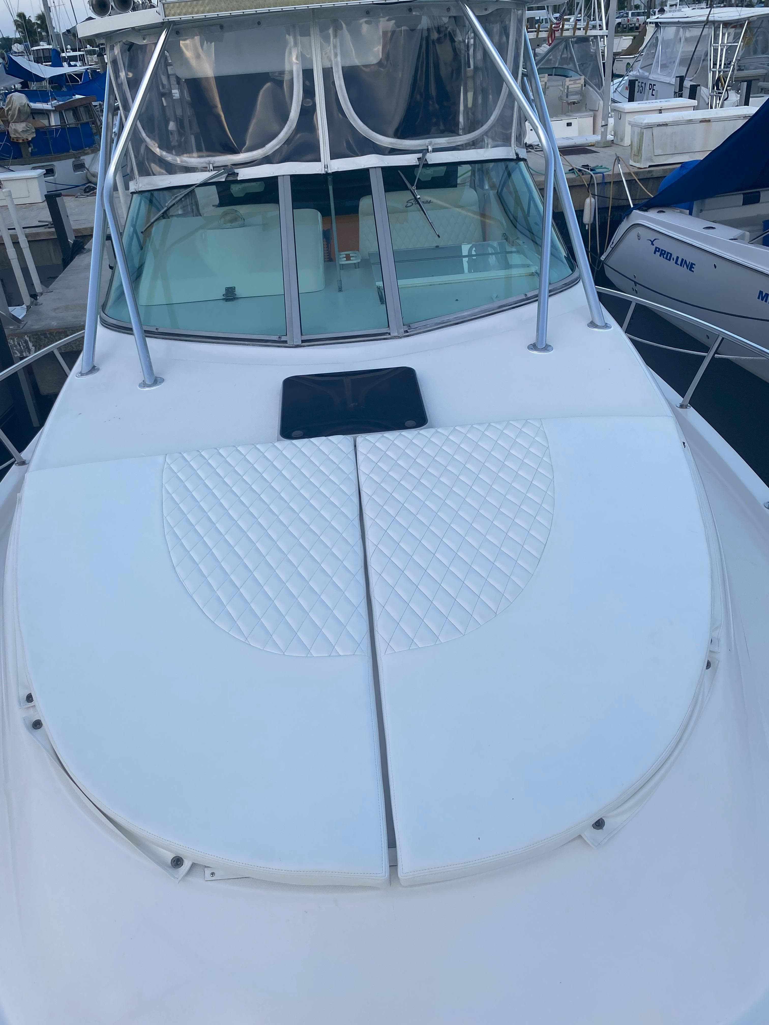 2006 Stamas 320 Express boat with spacious deck and sleek design at marina.