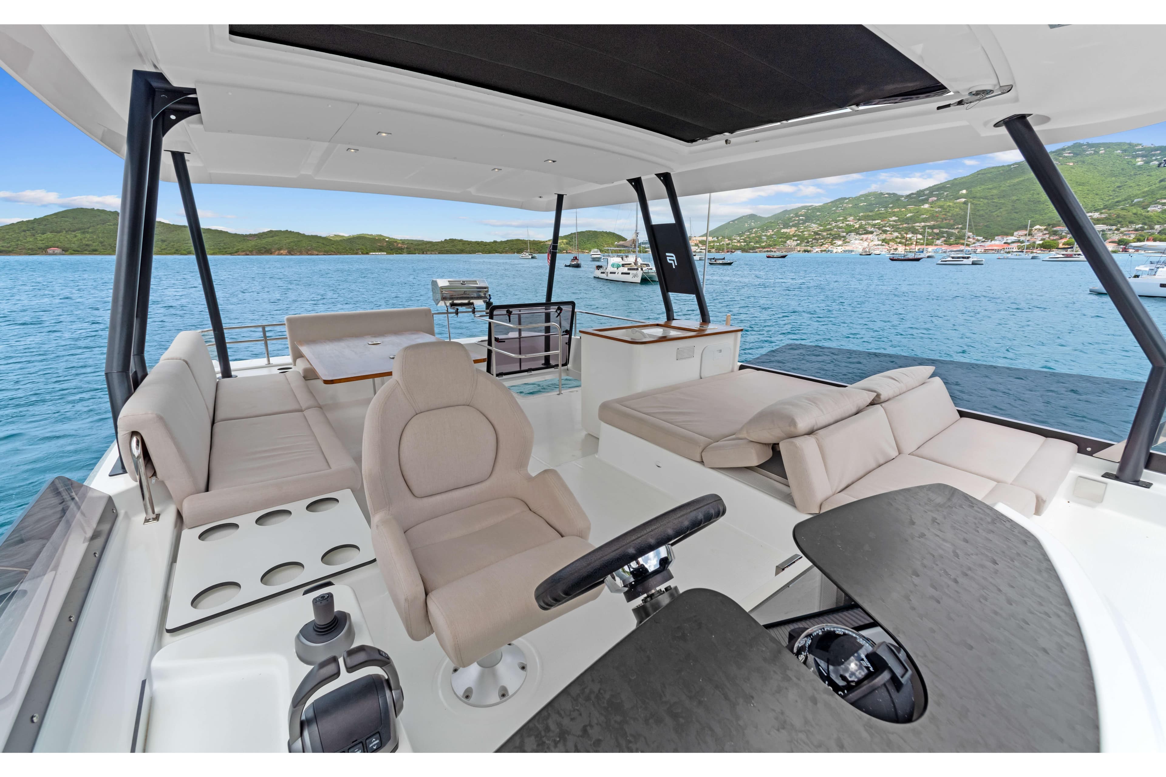 Luxurious 2024 Fountaine Pajot MY6 yacht interior with spacious seating and scenic ocean view.