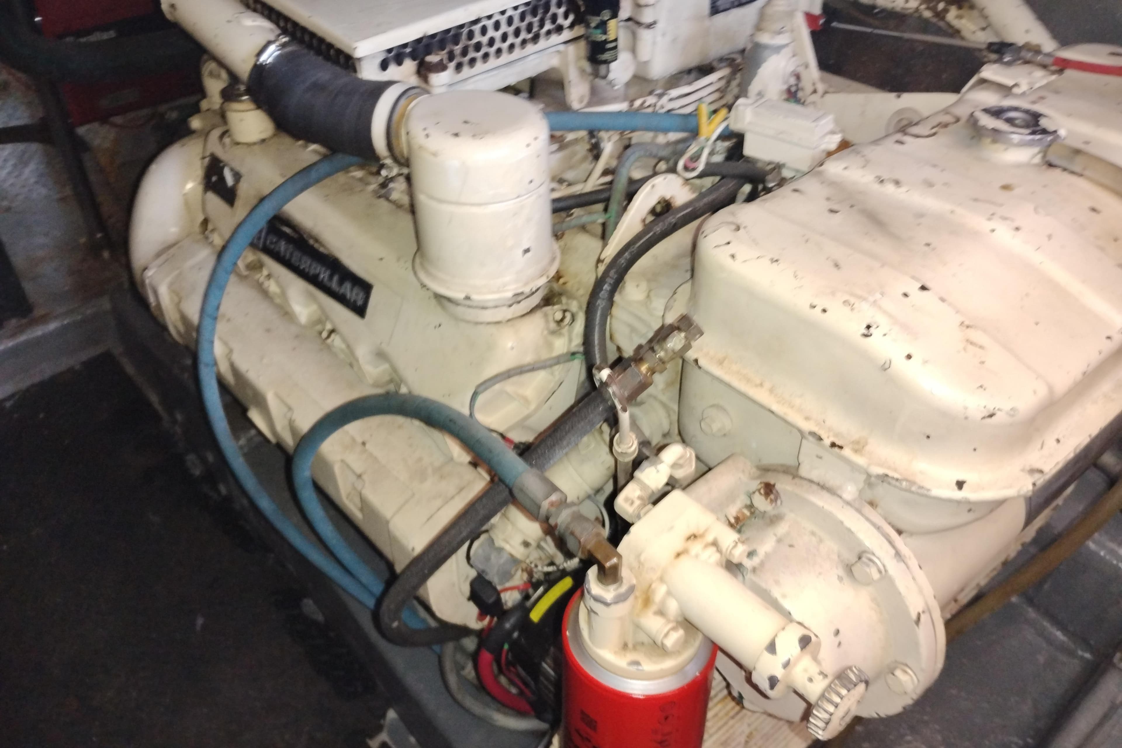 Engine of 1988 PT 52 AFT Cabin Motor Yacht, showing mechanical components and hoses.