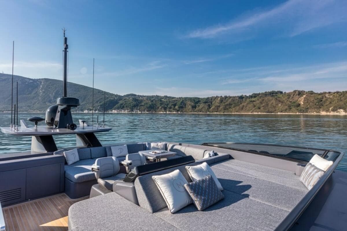 Luxurious 2021 Palumbo Extra 86 yacht with elegant outdoor seating and scenic coastal view.