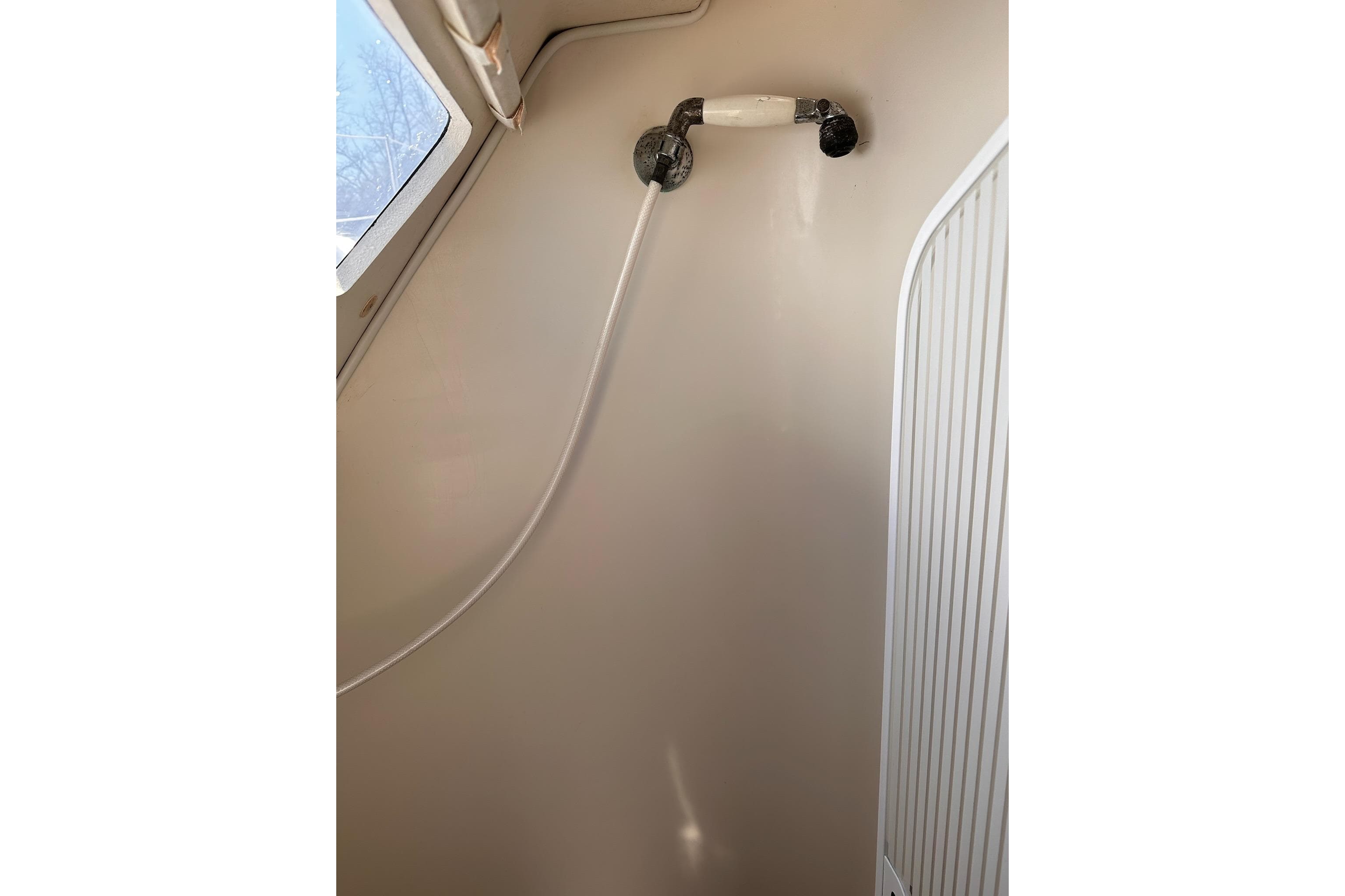 Interior view of a 2002 Catalina 400 MkII sailboat shower area with window.