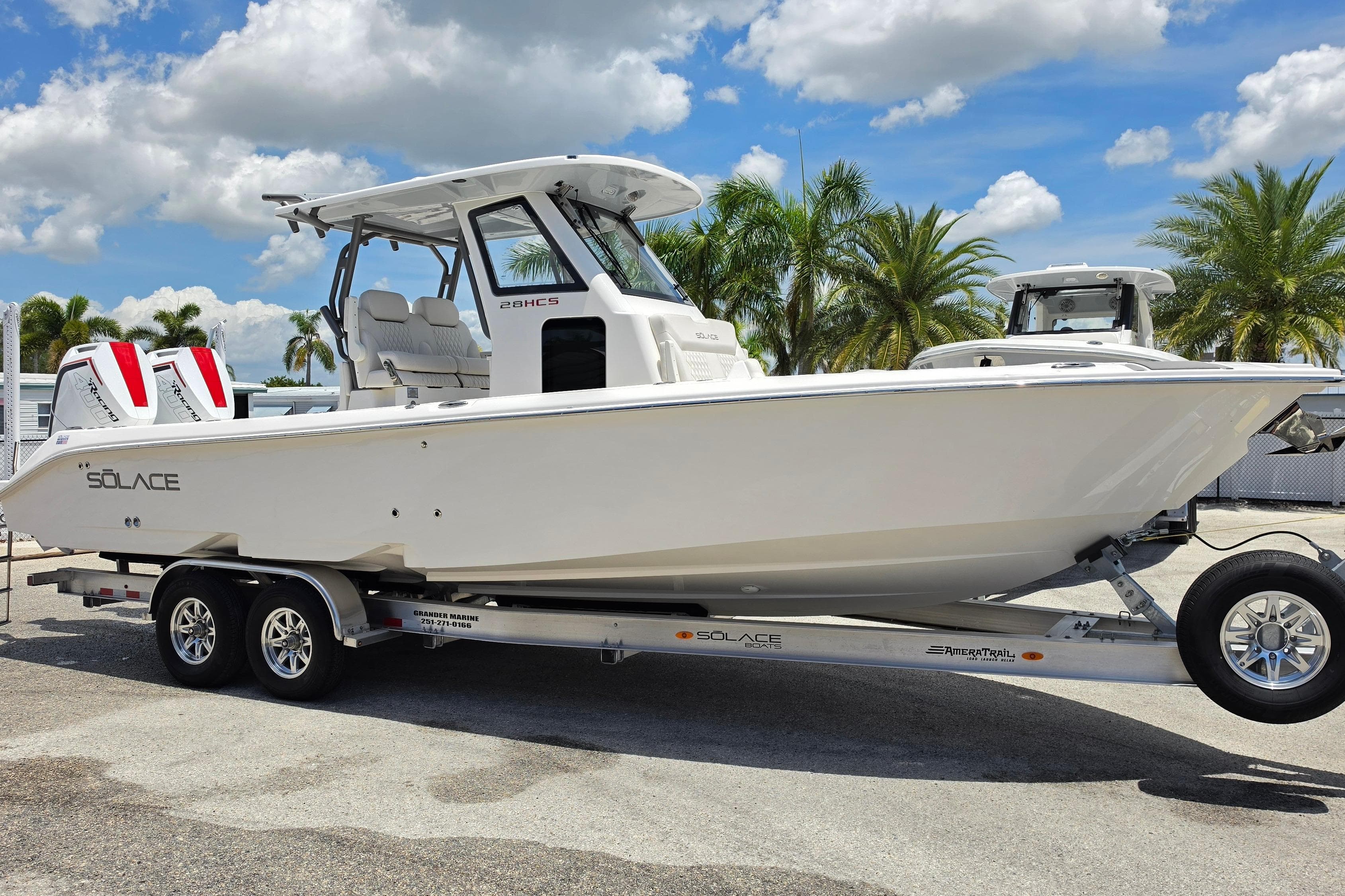 2026 Solace 28HCS boat on trailer, parked outdoors under a blue sky.