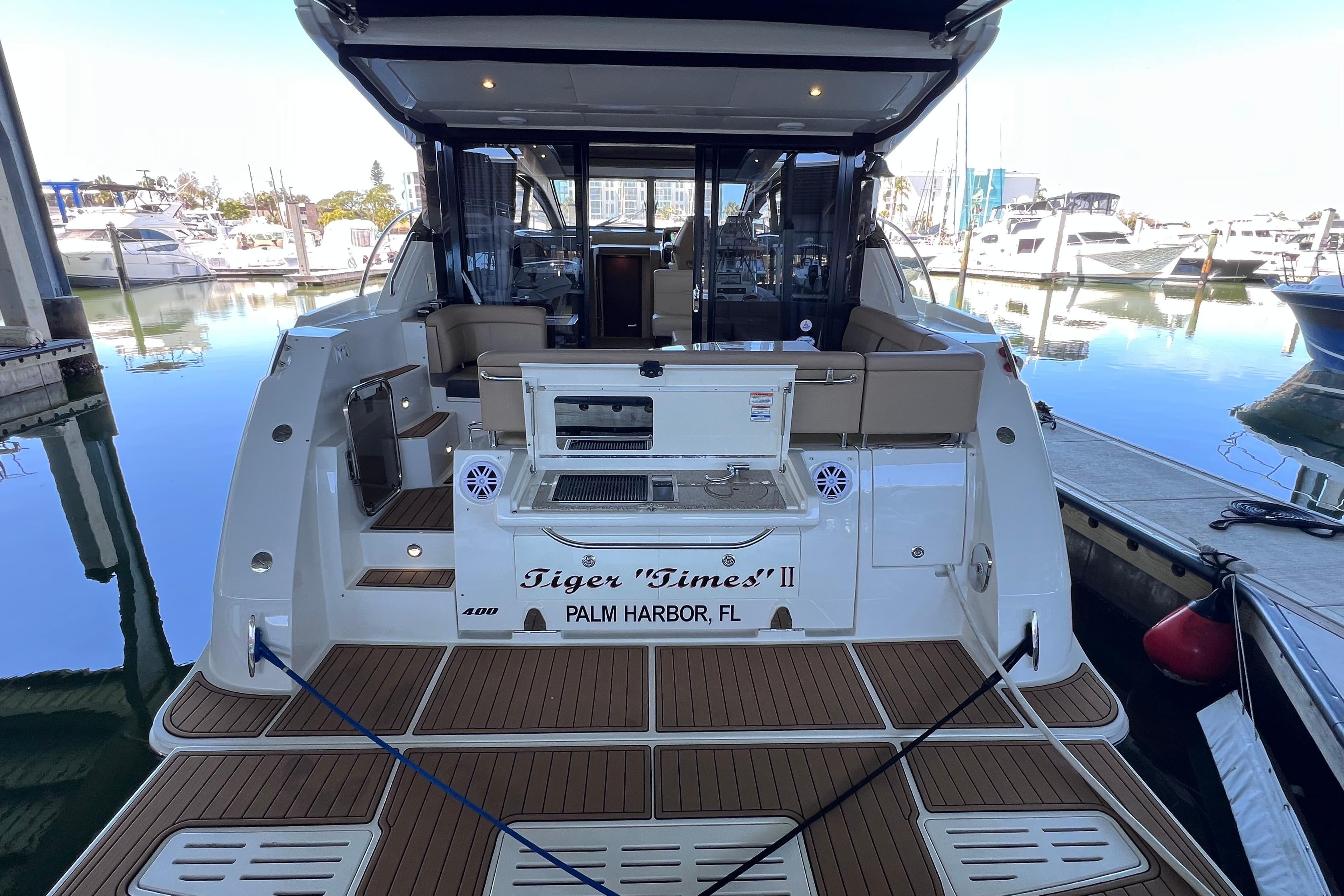2017 Sea Ray Sundancer 400 docked at marina, rear view with open deck.