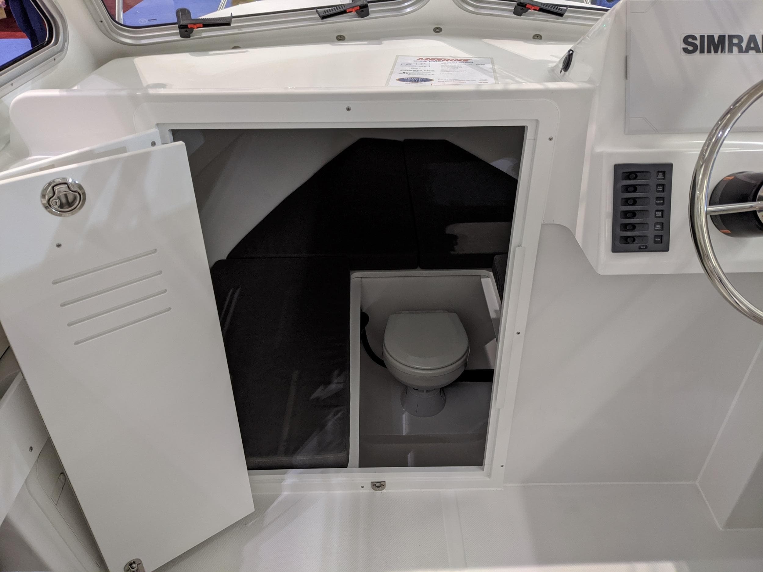 2020 Maritime 23 Challenger boat interior with compact cabin toilet.