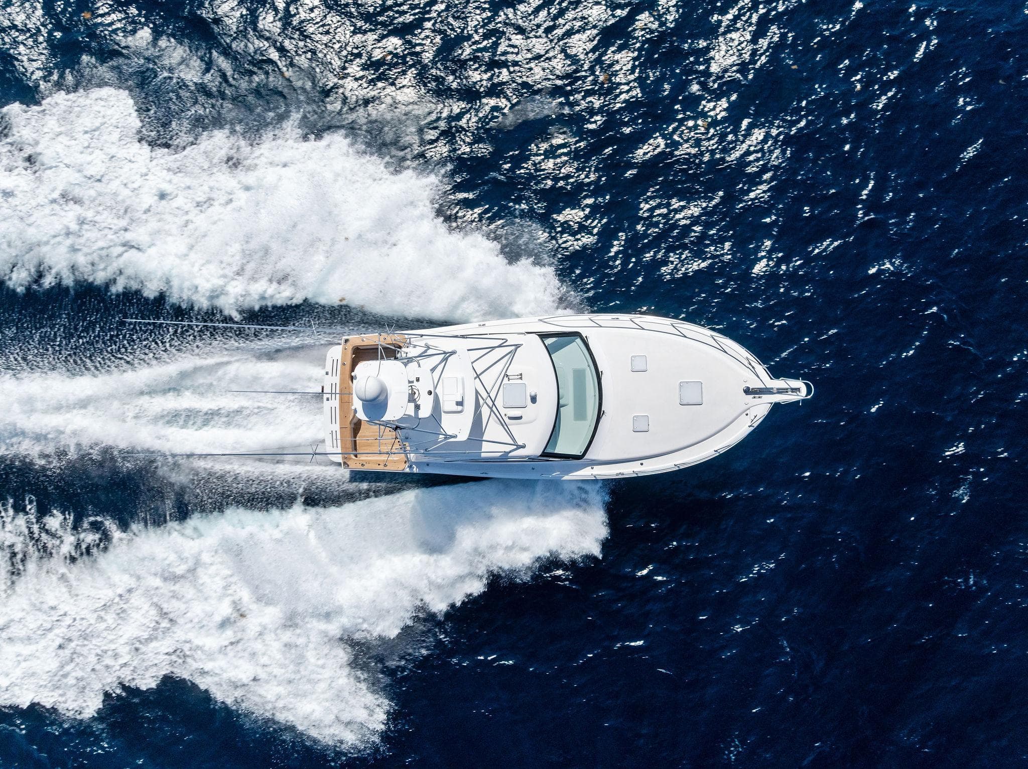 Aerial view of 2016 Hatteras Express Sportfish yacht cruising on open water.