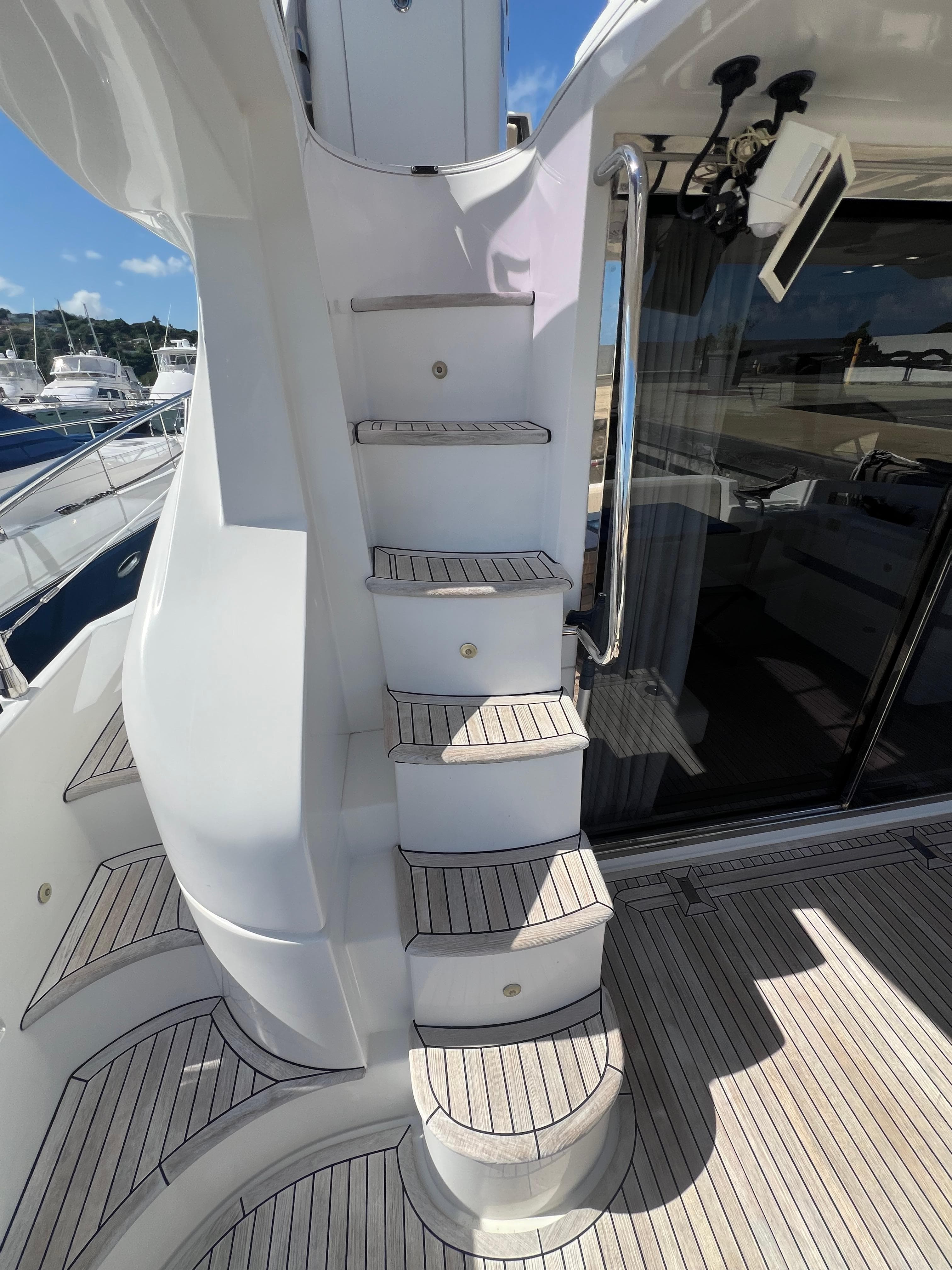 Staircase on 2016 Azimut 54fly yacht, featuring sleek design and wooden steps.
