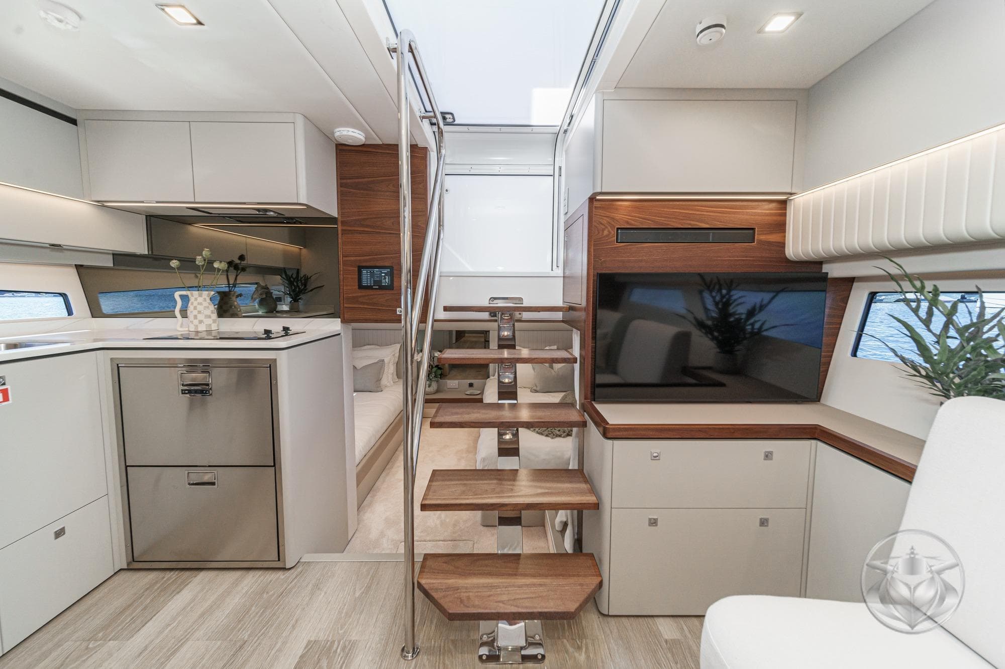 Luxurious interior of 2026 Riviera 4300 Sport Express yacht with modern kitchen and stylish decor.