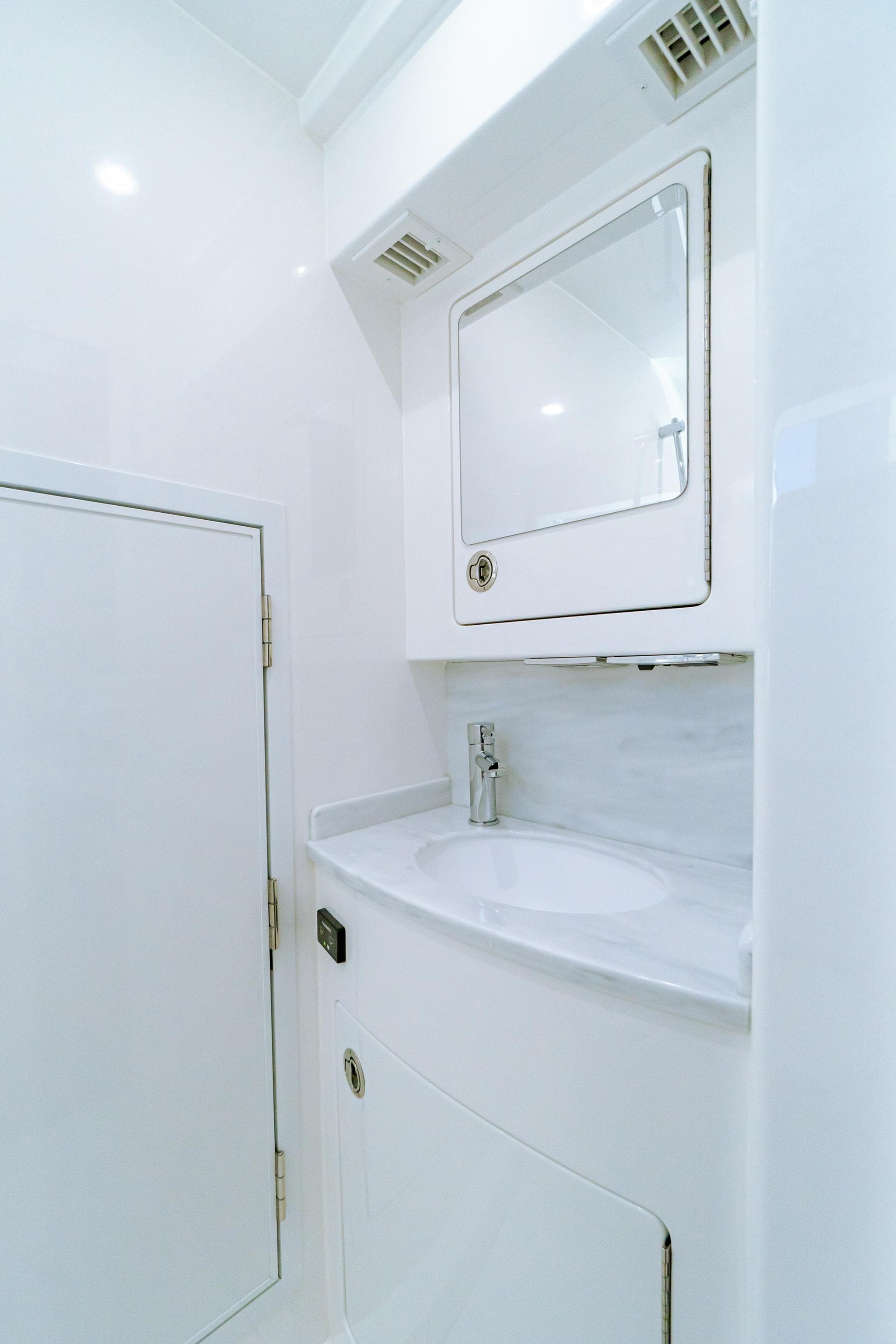 2025 Valhalla Boatworks V-46 bathroom with sleek white design and modern fixtures.