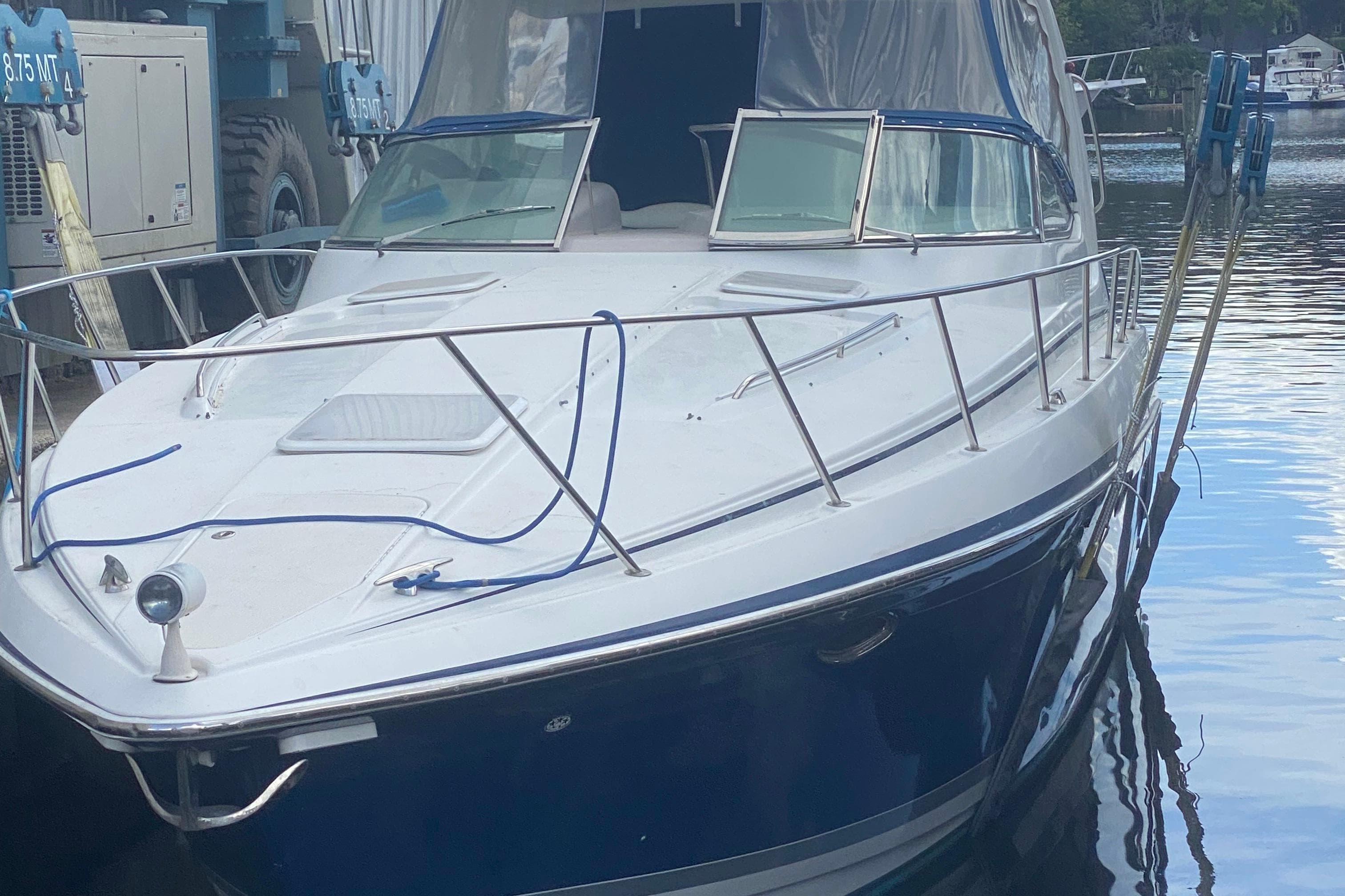 2005 Formula boat docked, featuring sleek design and blue accents.