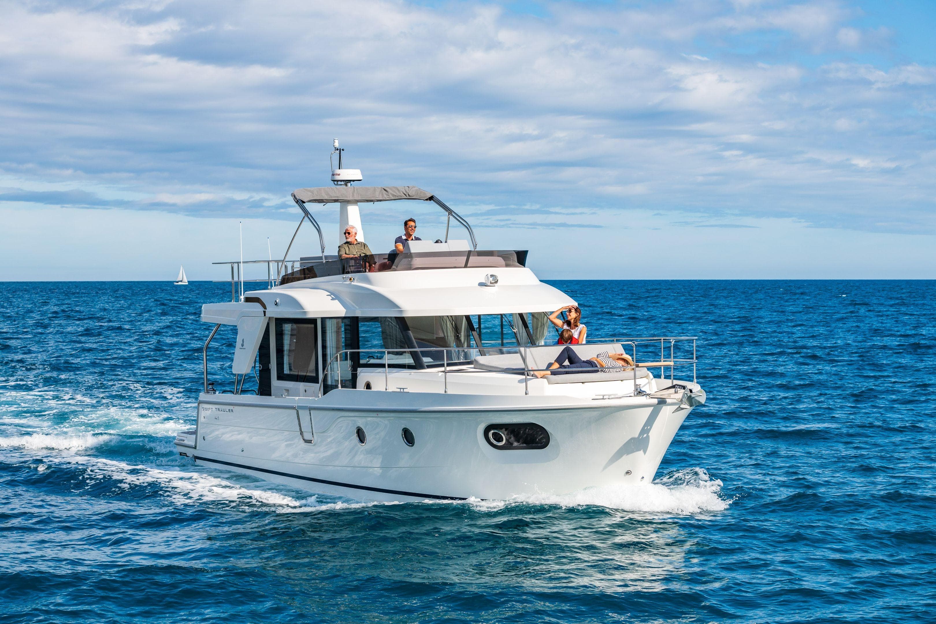 2026 Beneteau Swift Trawler 41 Fly cruising on open sea under clear skies.