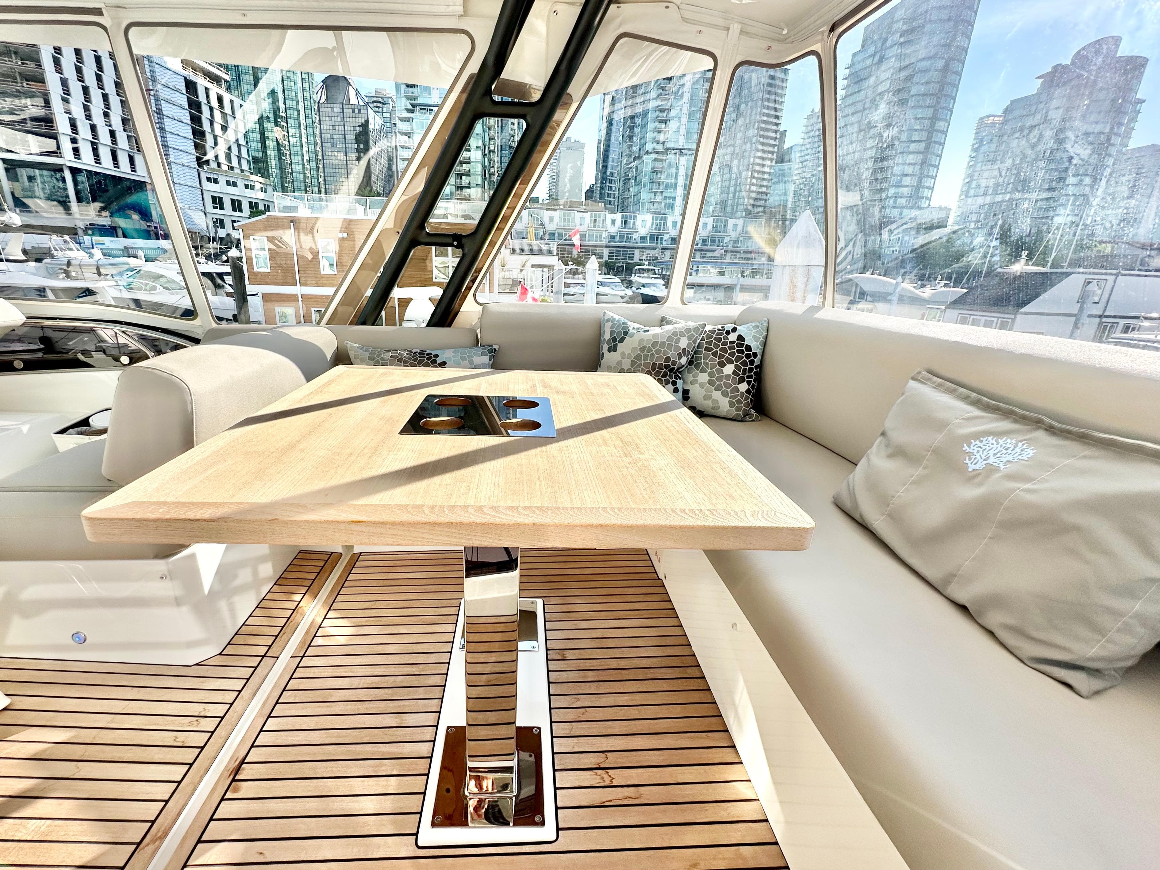 Luxurious interior of 2023 Prestige 520 yacht with cityscape view.