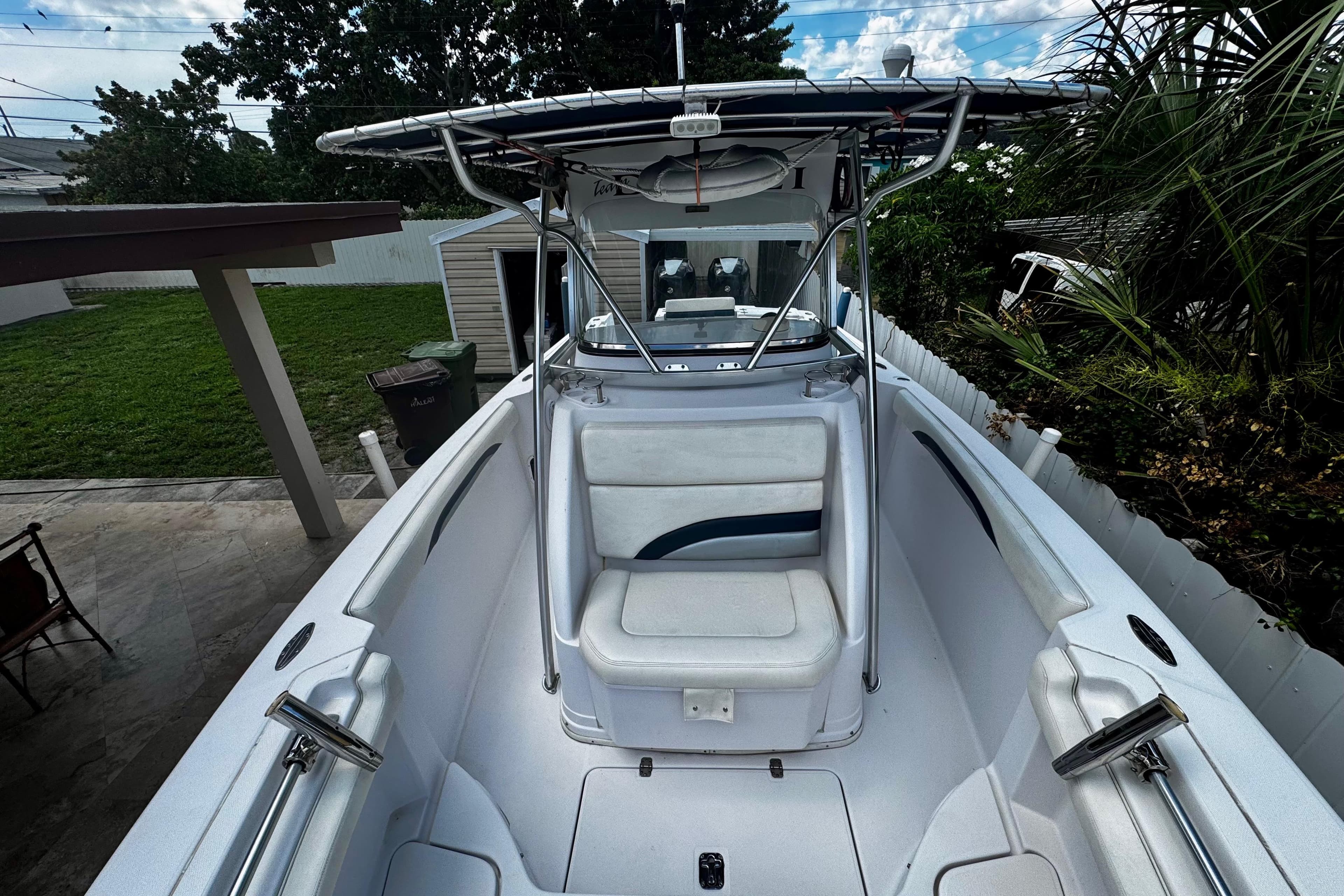 2006 Donzi 32 ZF boat with seating, parked in a backyard setting.