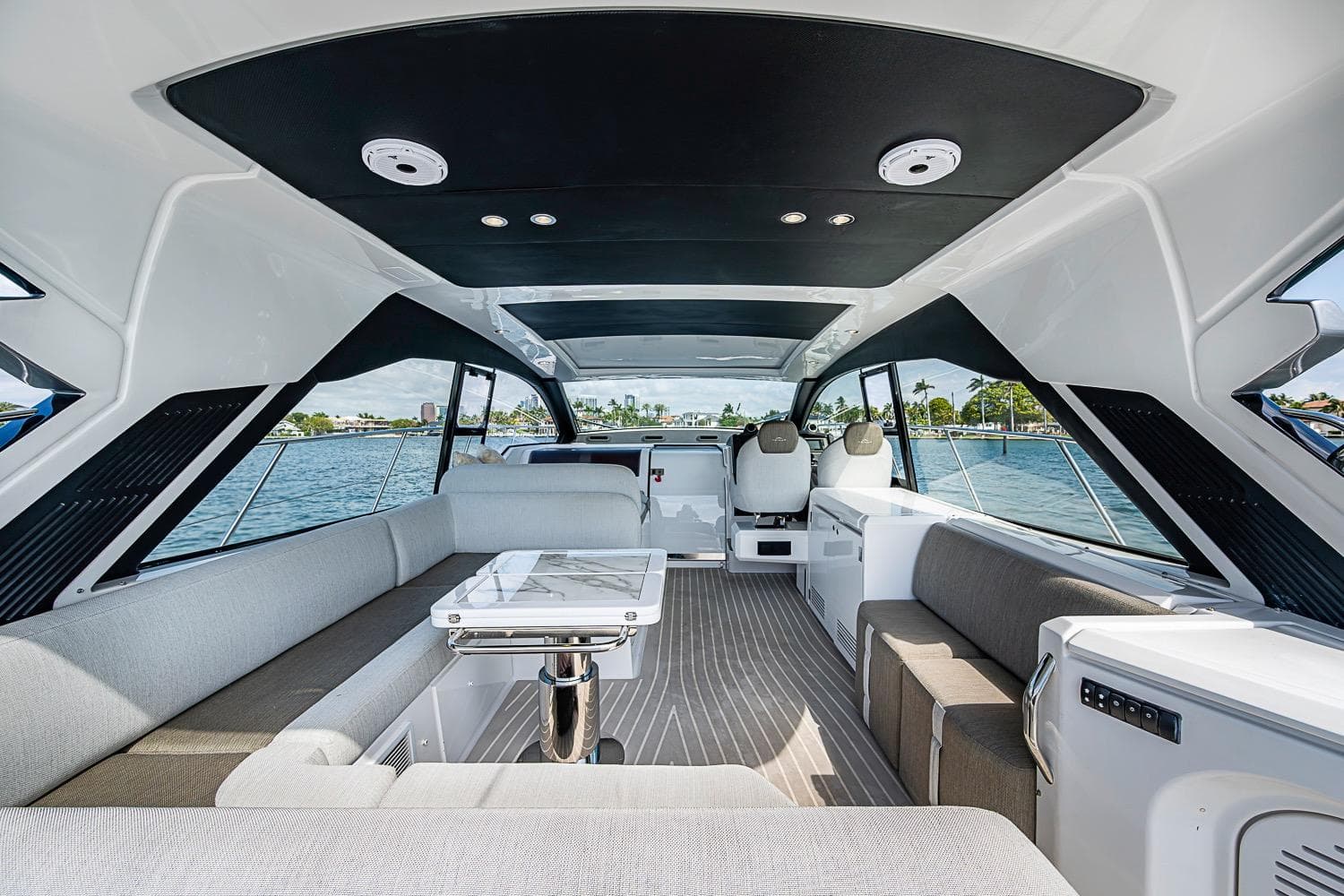 Luxurious interior of 2019 Azimut Atlantis 51 yacht with modern seating and panoramic windows.