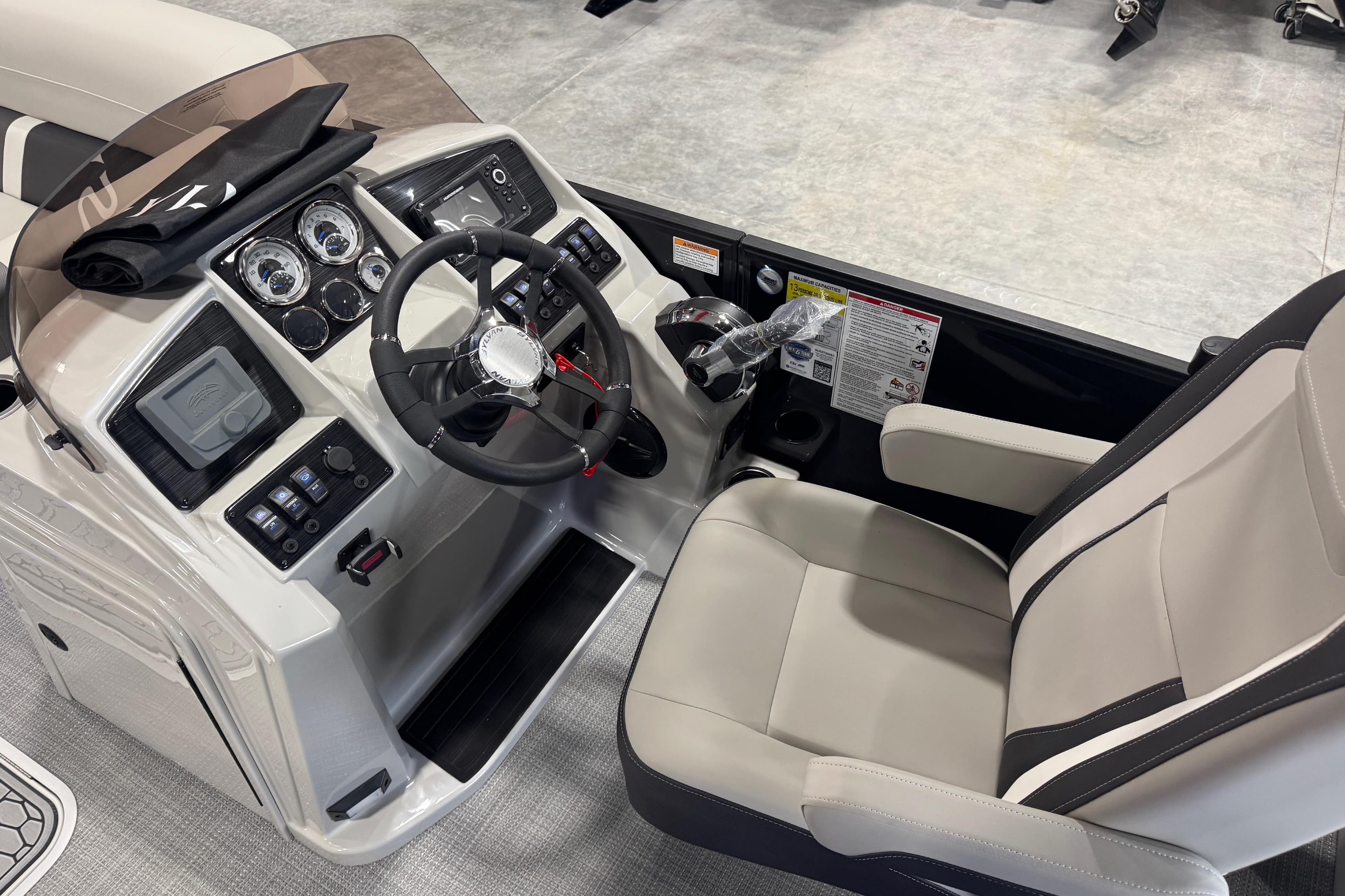 2026 Sylvan X5 boat cockpit with modern steering and control panel.