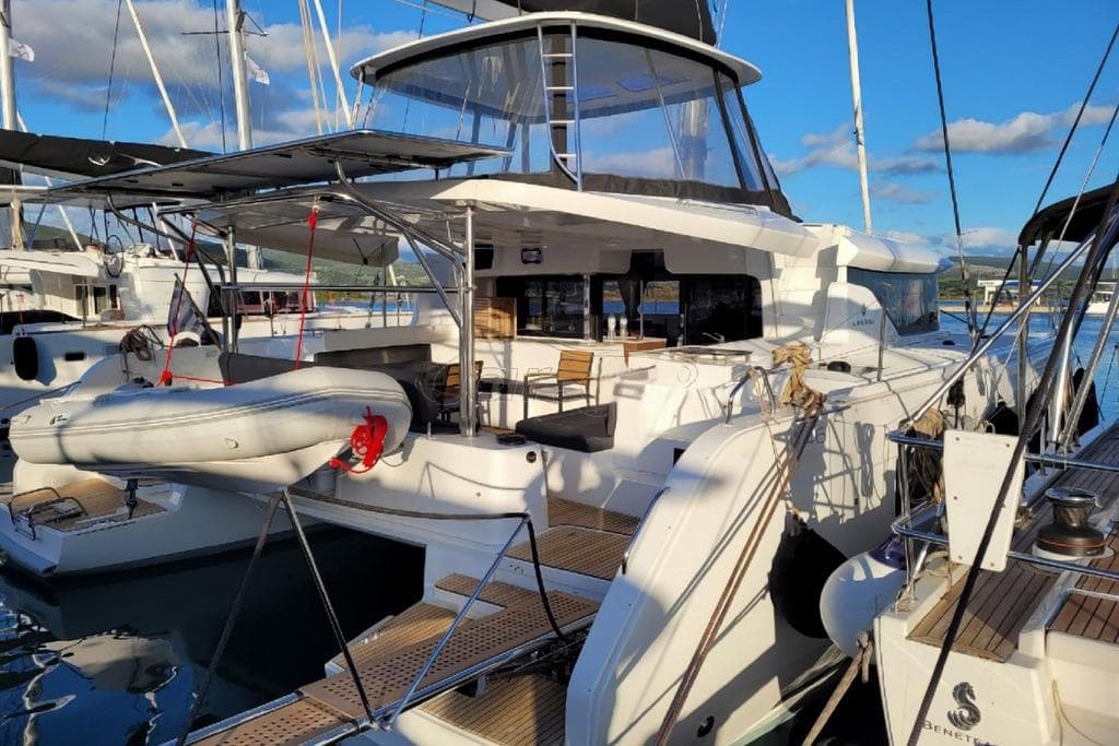 2021 Lagoon 46 catamaran docked at marina, featuring spacious deck and modern design.