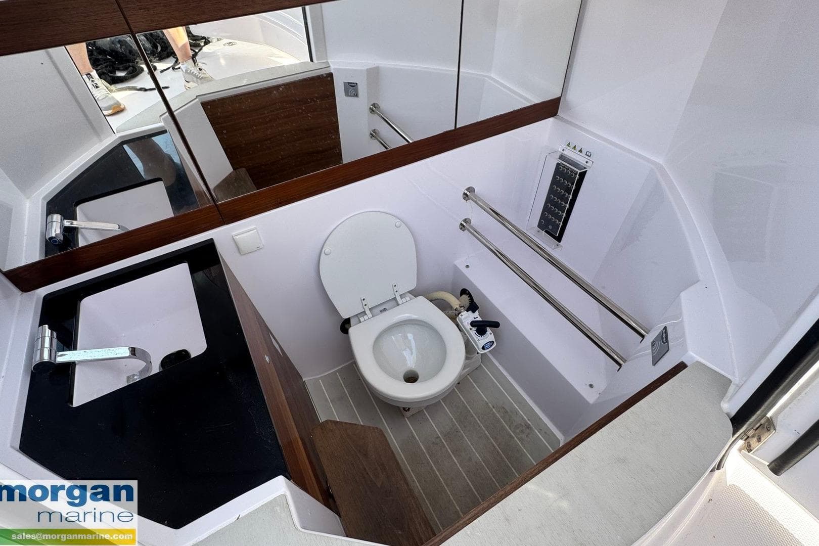 2021 Axopar 28 Cabin boat bathroom with modern fixtures and sleek design.