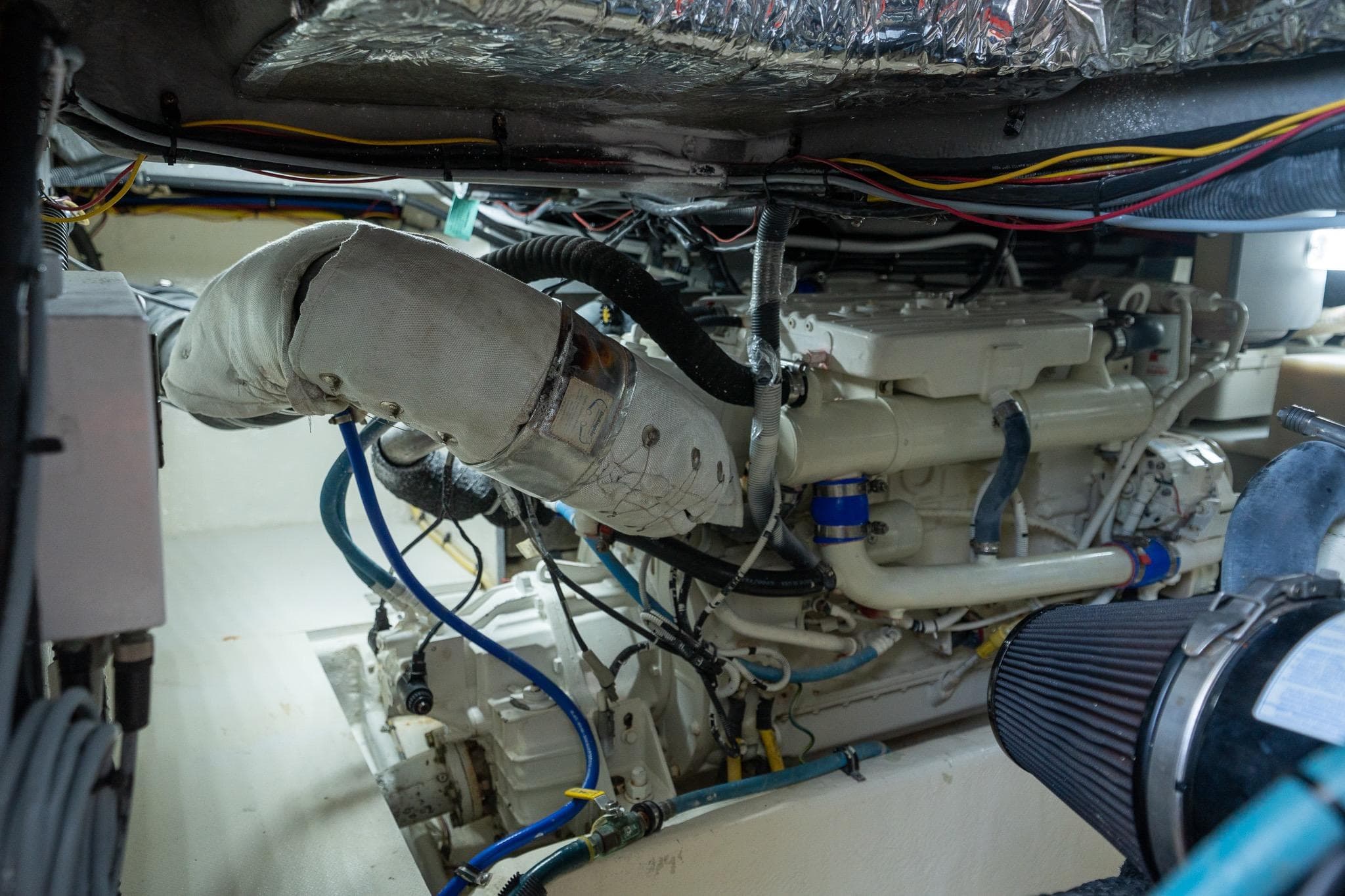 Engine room of a 2009 Meridian 391 Sedan yacht, showcasing mechanical components and wiring.