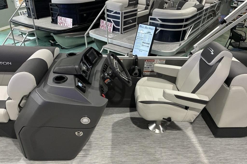 2026 Bennington S Quad Bench 22 SSR boat interior with captain's chair and control panel.