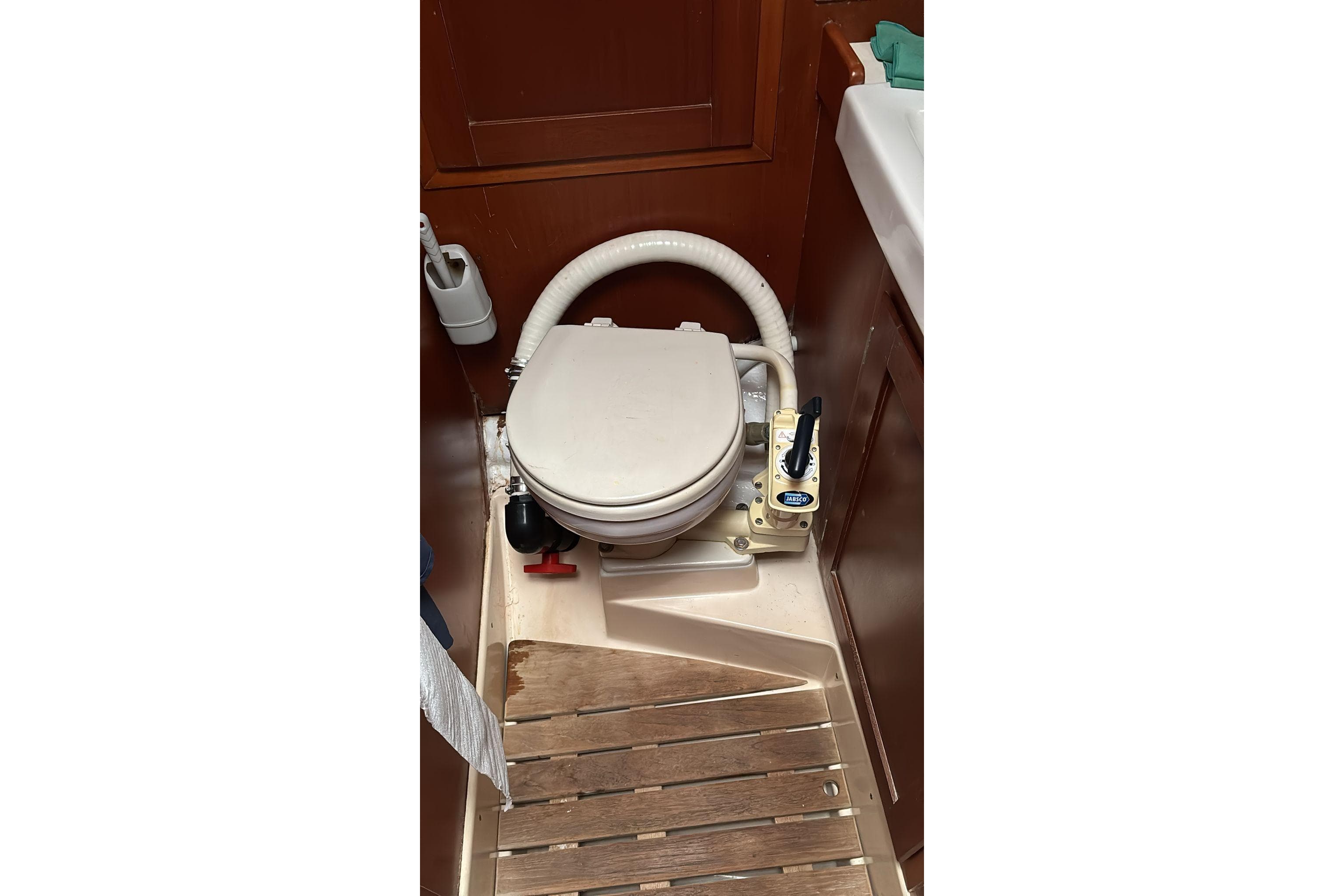 1984 Halberg Rassy HR 352 yacht bathroom with marine toilet and wooden flooring.
