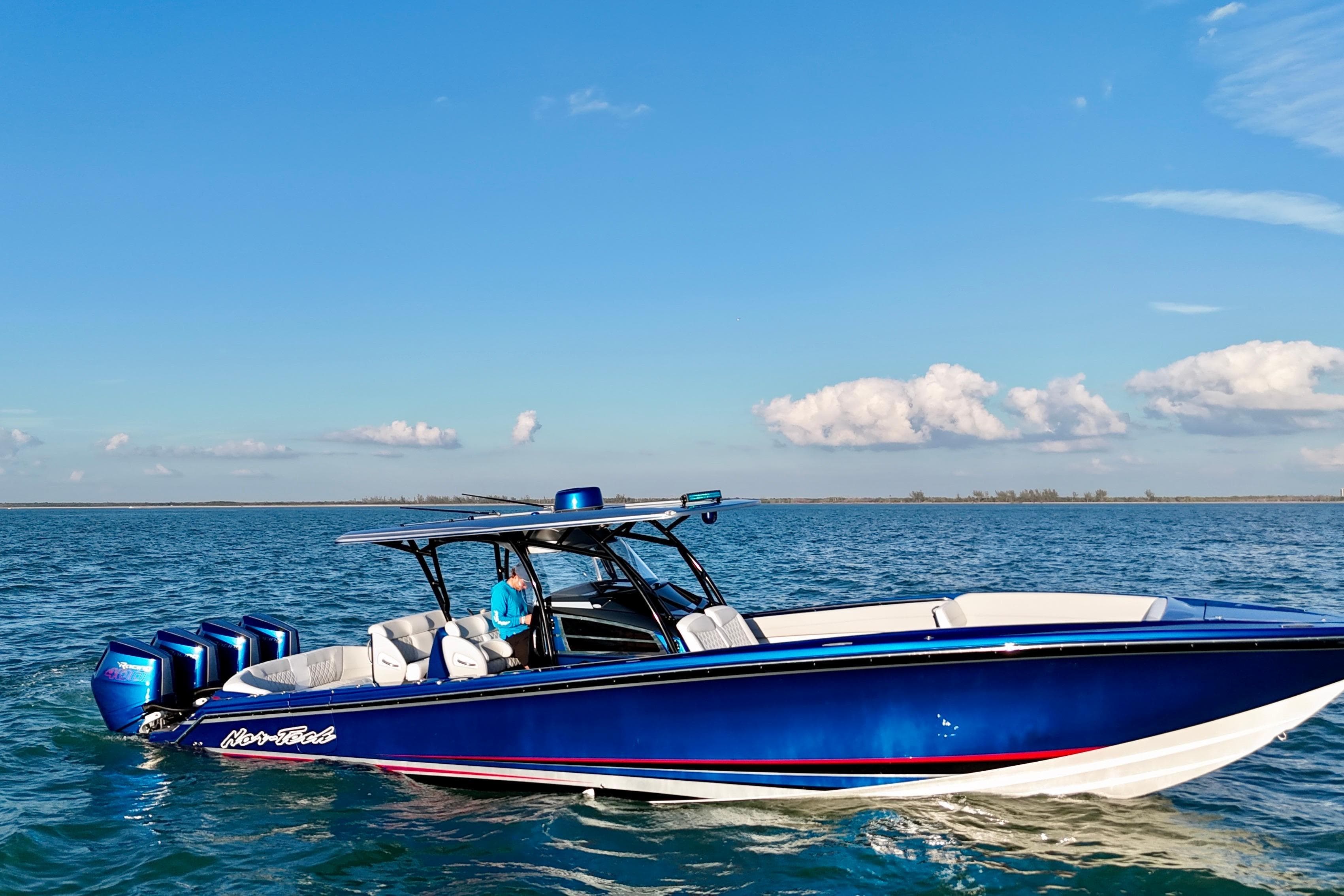 2026 Nor-Tech 390 Sport Center Console boat cruising on open water under clear skies.