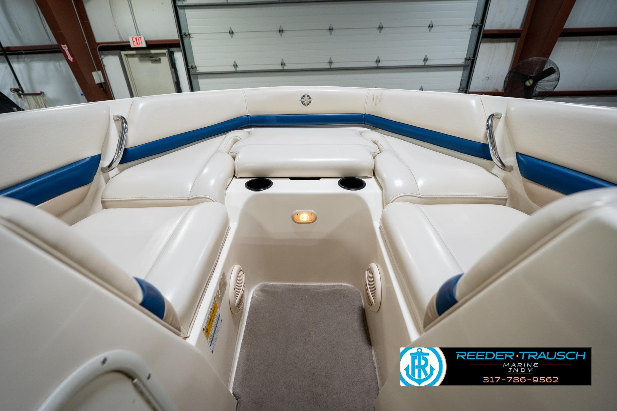 Interior of a 2000 Bryant 196 Limited boat with white and blue seating.