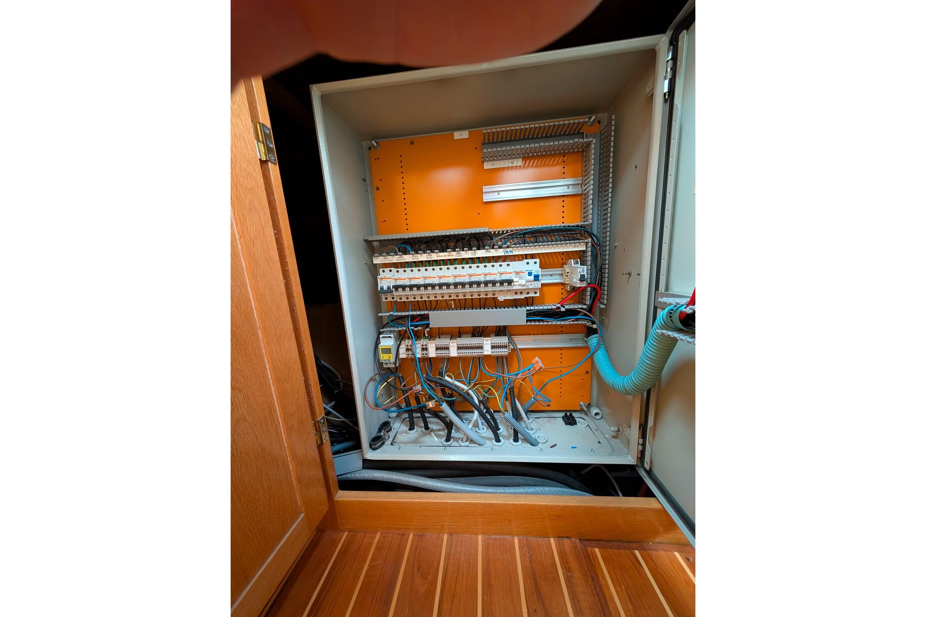 Electrical panel inside a Kempers 49 yacht, showcasing wiring and circuit breakers.