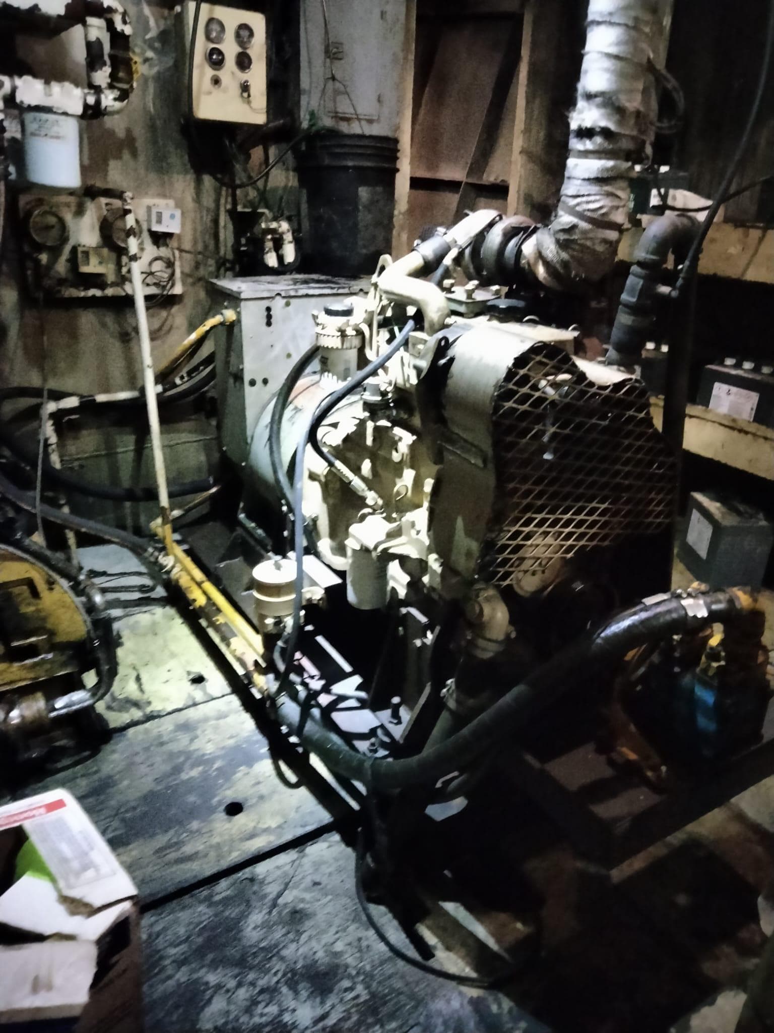 Engine room of a 1972 Commercial Shrimp Freezer Trawler, featuring machinery and pipes.