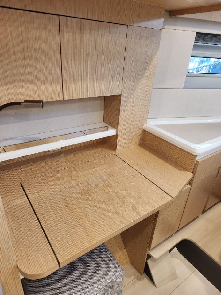 Modern interior of 2025 Moody 48 DS yacht with sleek wooden cabinetry.