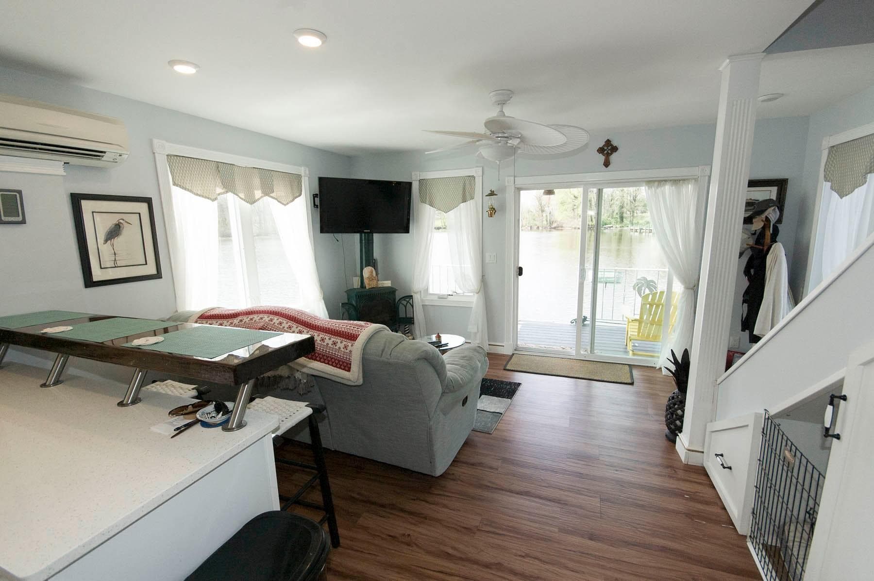 2017 Chesapeake 48 Houseboat interior with cozy living area, large windows, and lake view.