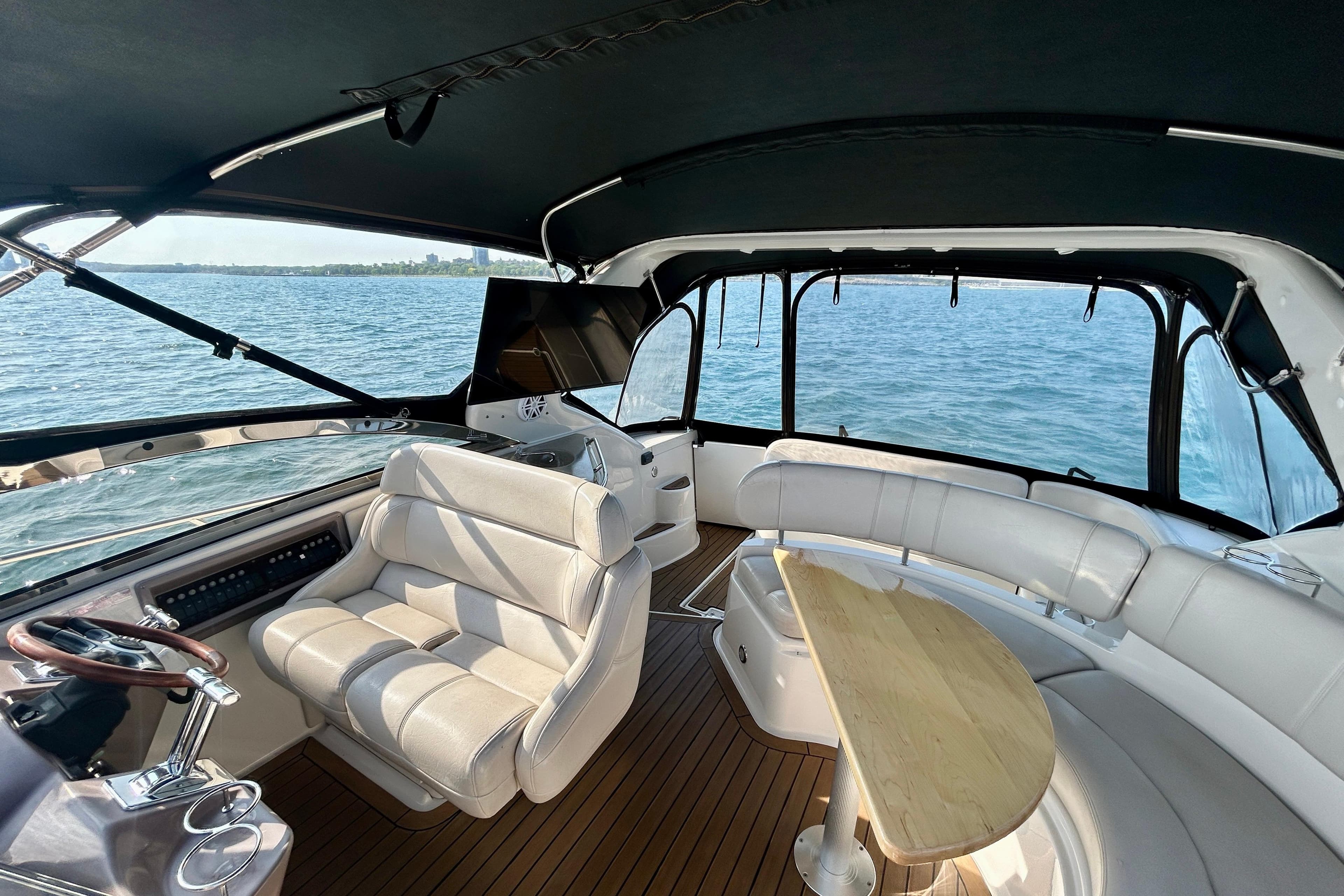 2002 Regal Commodore 3860 yacht interior with seating and table on open water.