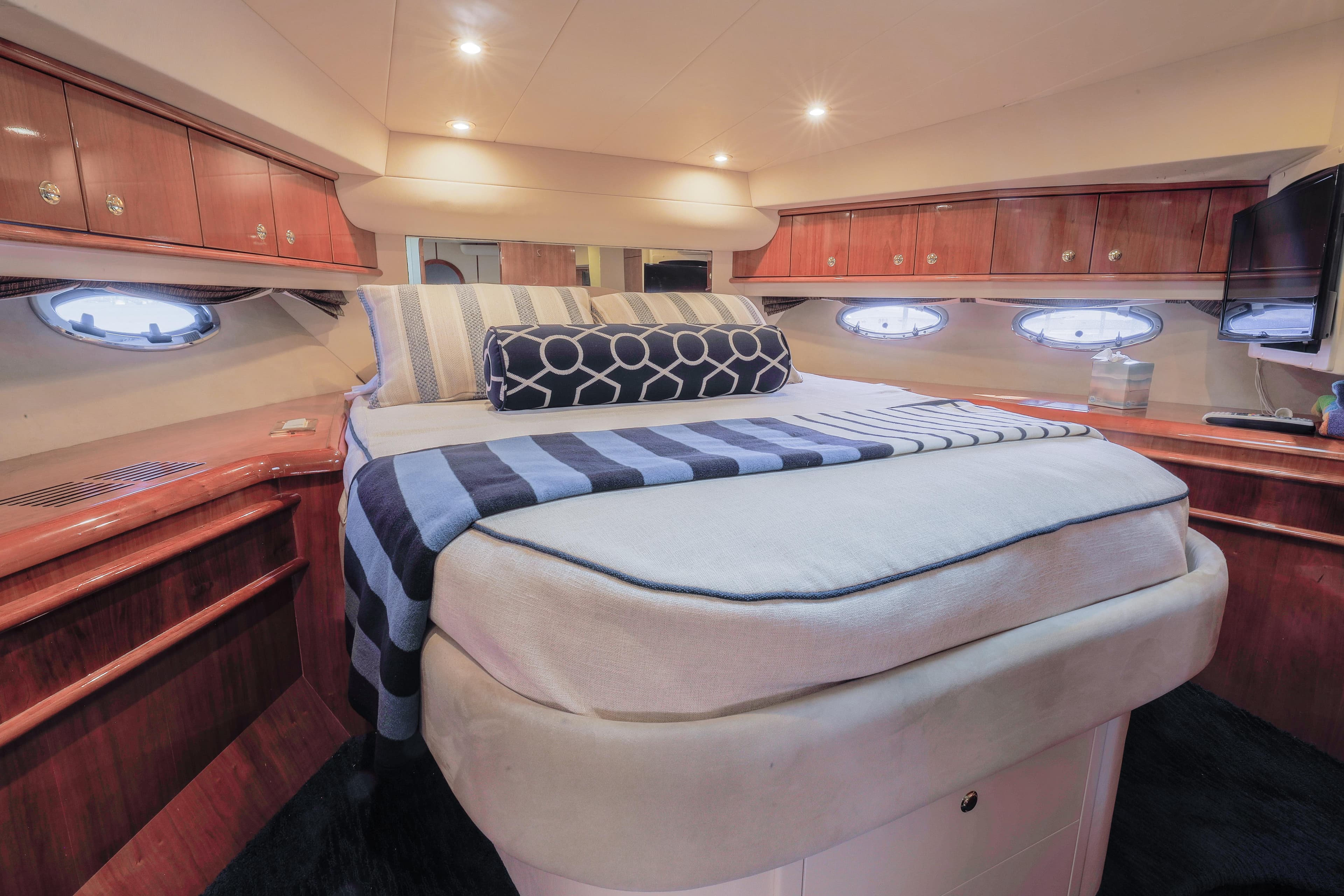 Luxurious cabin interior of 2000 Neptunus 54 Express yacht with elegant wood finishes.