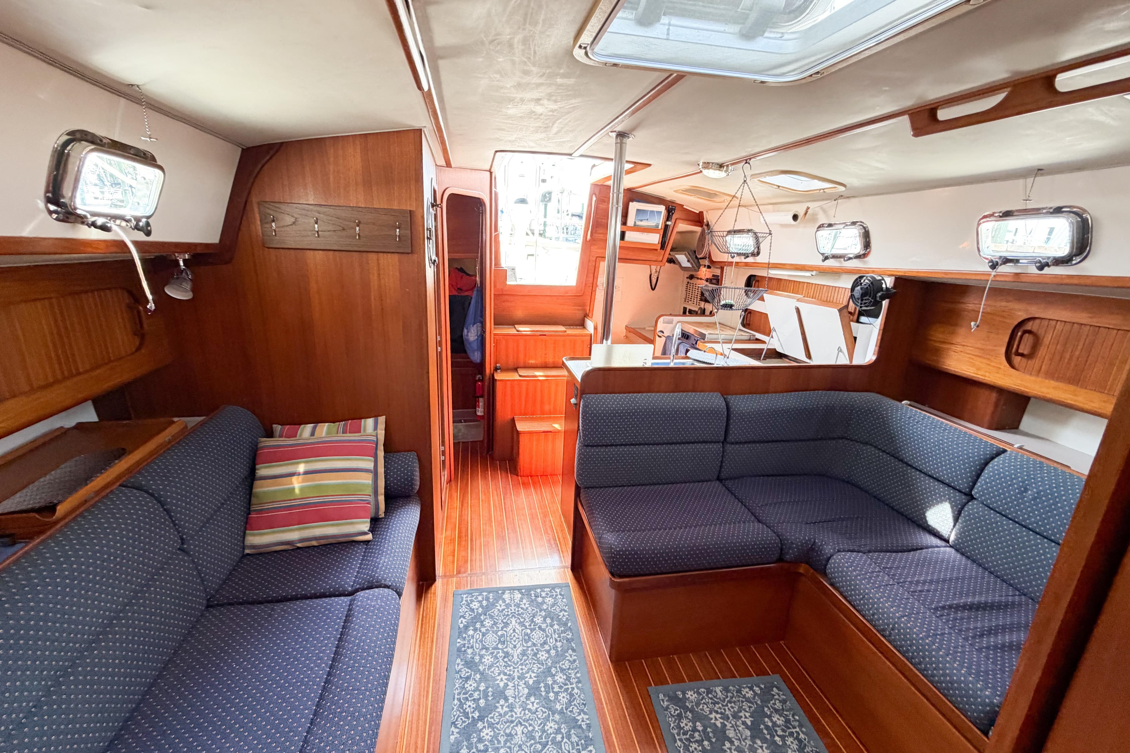 Interior of 2001 Caliber 40LRC sailboat with cozy seating and wooden finishes.
